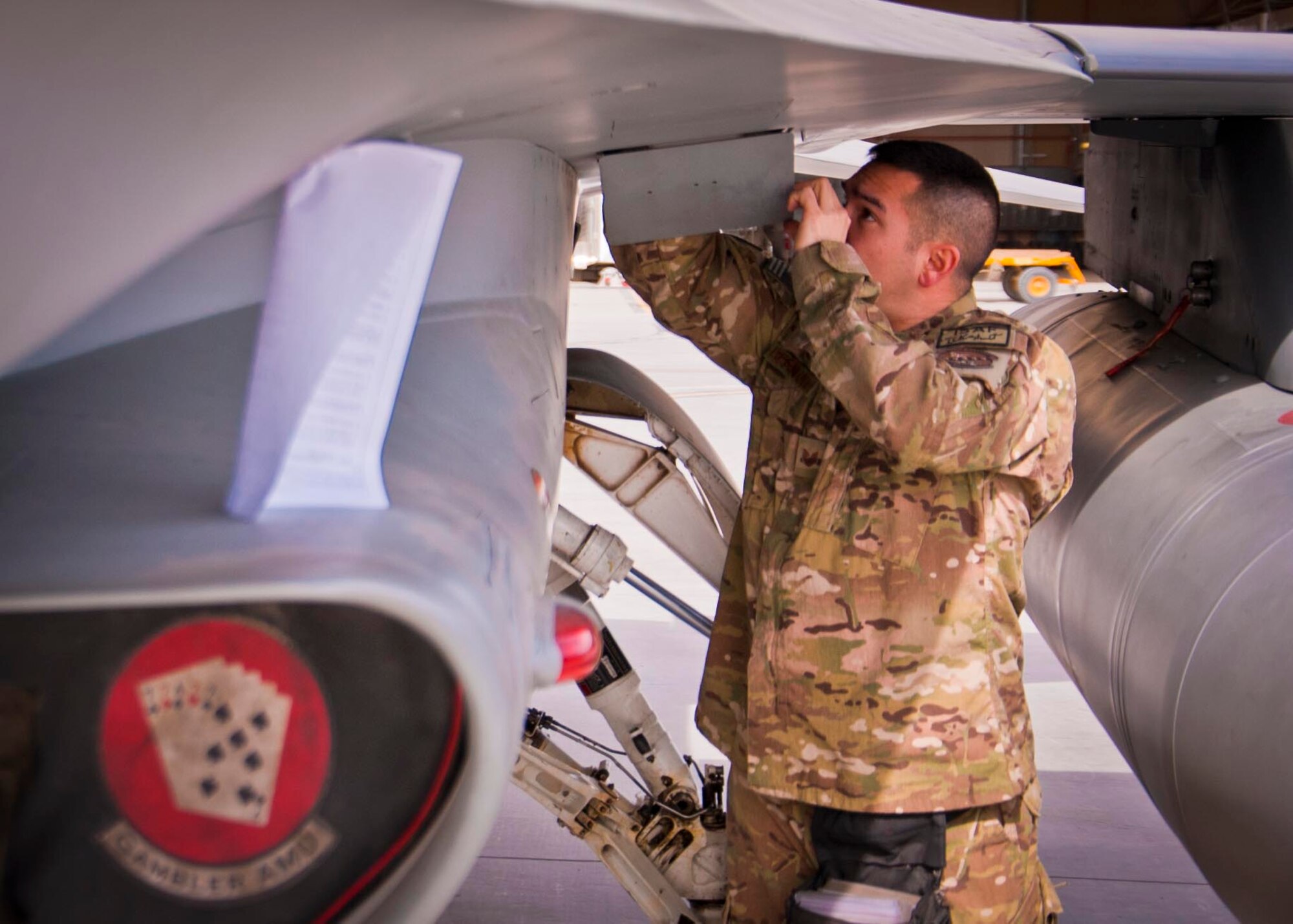 KANDAHAR AIRFIELD, Afghanistan -- Staff Sgt. William Bernhardt, 451st Expeditionary Aircraft Maintenance Squadron weapons load team chief, inspects a 20mm gun system on an F-16 Fighting Falcon during a weapons load competition here Feb. 11. Bernhardt and two other Airmen made up a three-man weapons load crew and completed a four-phase evaluation. Their overall score will be put up against other scores of weapons load crews from their home station, Shaw Air Force Base, S.C. (U.S. Air Force photo/Senior Airman Scott Saldukas) 