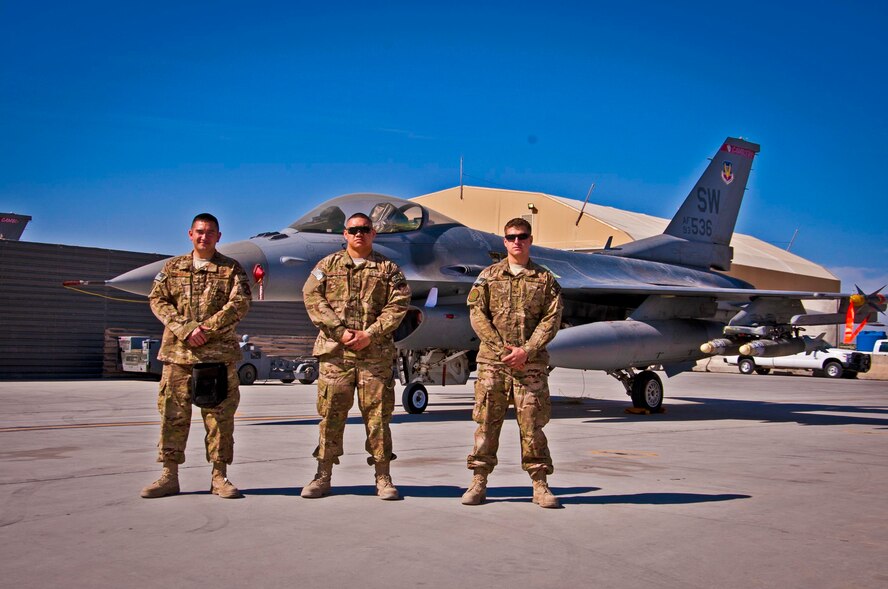 KANDAHAR AIRFIELD, Afghanistan – (From left to right) Crew 07, Staff Sgt. William Bernhardt, from Valdosta, Ga., Senior Airman Matthew Furey, from Mente Vista, Calif., and Senior Airman Kameran Fernandez, from Maui, Hawaii, are deployed here from Shaw Air Force Base, S.C. The three Airmen competed in a weapons load competition here Feb. 11. The three-man crew completed four separate phases of the competition and their overall score will compete against other load crew’s scores back at their home station. (U.S. Air Force photo/Senior Airman Scott Saldukas)