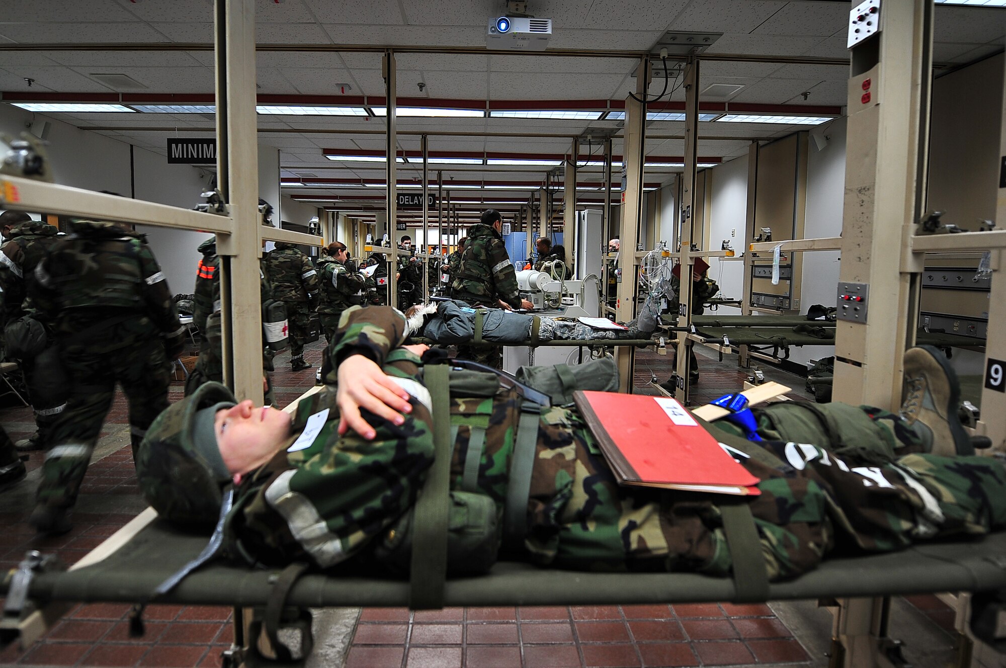 A mock victim lies on a stretcher in the Garden Court, a triage facility located inside the 51st Medical Group’s hospital, during an operation readiness exercise, Beverly Bulldog 13-02, at Osan Air Base, Republic of Korea, Feb. 12, 2013. Osan’s Hospital maintains the Garden Court in case space is needed to care for multiple patients at a time.  Exercises like BB 13-02 allow the base to operate in heightened states of readiness to prepare for an upcoming inspection in April and real world contingencies. (U.S. Air Force photo/Staff Sgt. Sara Csurilla)