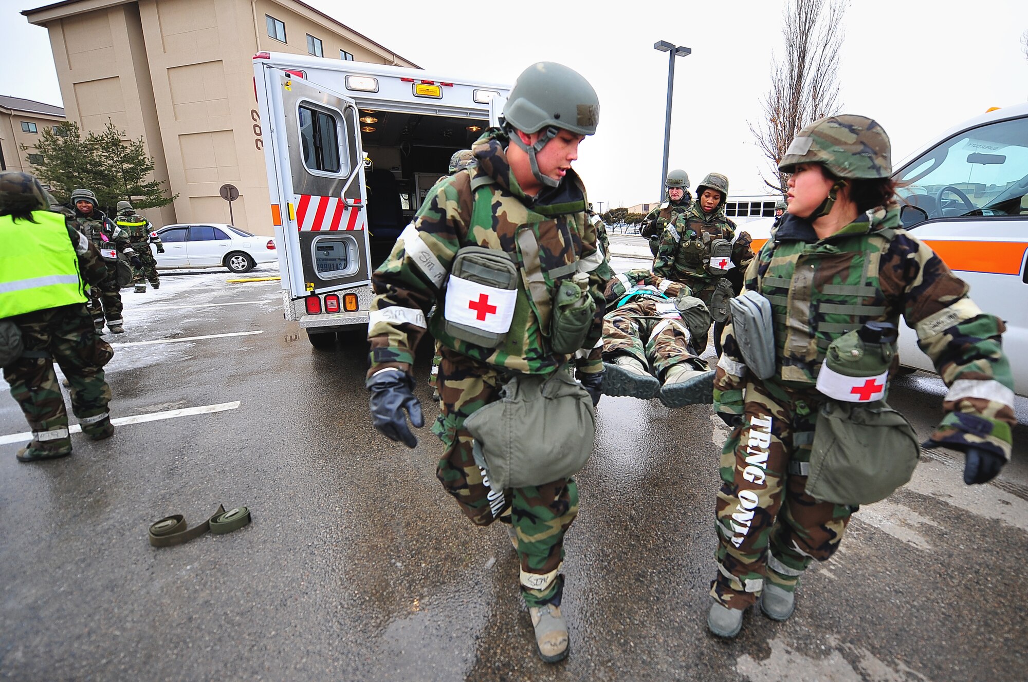 Senior Airman Doran Gilstrap, left, 51st Aerospace Medicine Squadron public health technician, and Capt. Eunlim Lee, 51st Dental Squadron general dentist, help carry a mock patient to an ambulance during a mass casualty scenario for an operation readiness exercise, Beverly Bulldog 13-02 at Osan Air Base, Republic of Korea, Feb. 12, 2013. Scenarios like these give Airmen a chance to hone wartime skills in a safe and structured environment in preparation for real-world contingencies. (U.S. Air Force photo/Staff Sgt. Sara Csurilla)