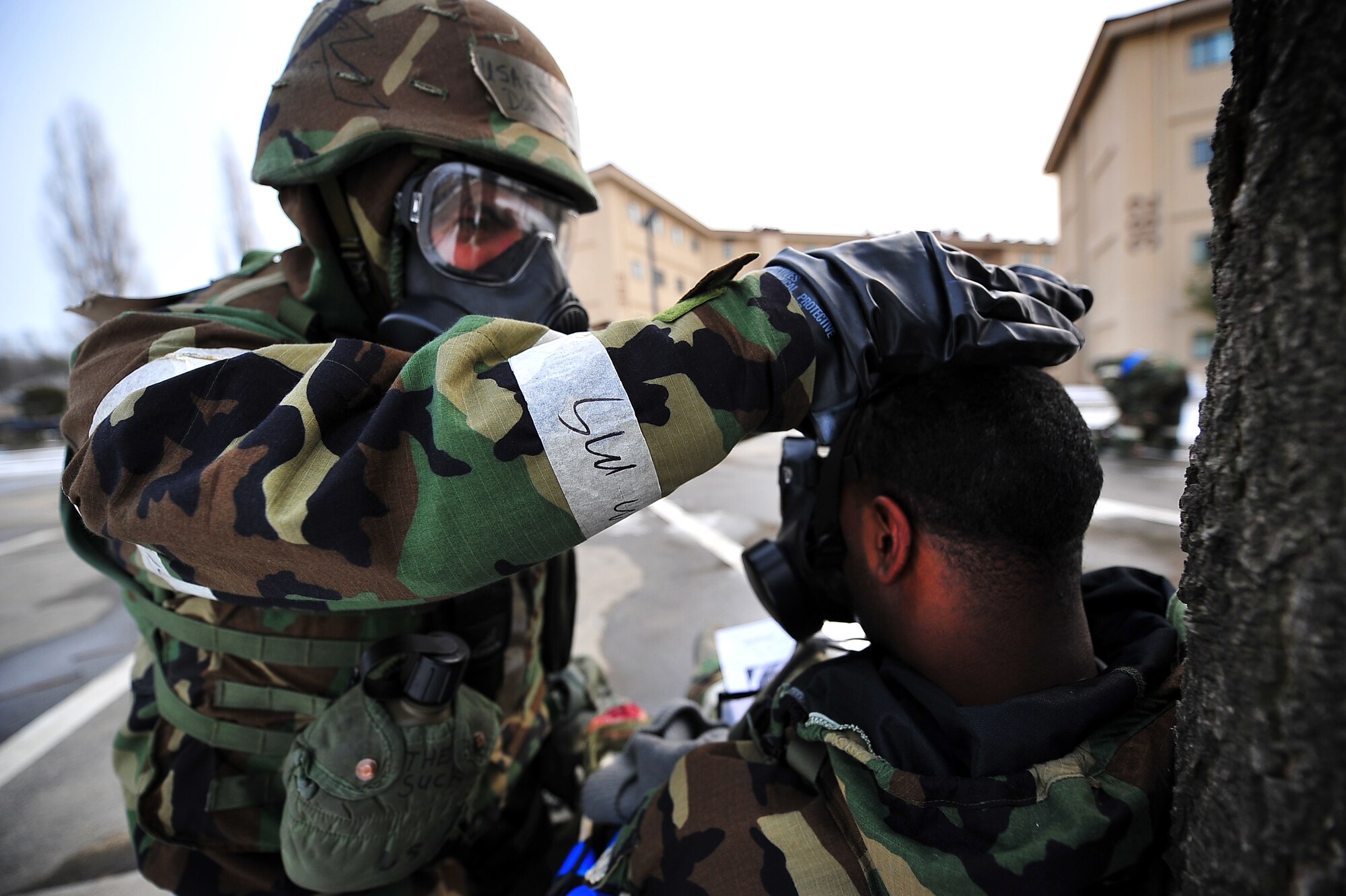 Tech Sgt. Douglas Pack, 51st Maintenance Group precision measurement equipment laboratory craftsman, puts a fellow Airman’s gas mask on after a mock mass casualty scenario as part of an operation readiness exercise, Beverly Bulldog 13-02, at Osan Air Base, Republic of Korea, Feb. 12, 2013. Scenarios like these ensure Airmen are prepared for real-world situations where self-aid, buddy-care is required as well as give Airmen a chance to hone wartime skills in a safe and structured environment in preparation for real-world contingencies. (U.S. Air Force photo/Staff Sgt. Sara Csurilla)