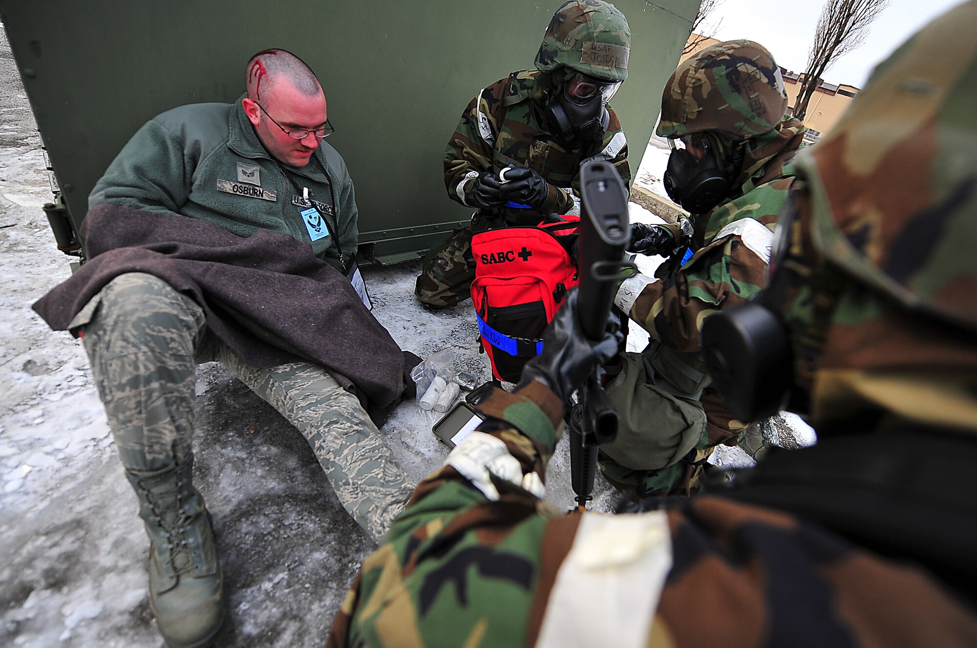 Senior Airman Joel Osburn, 51st Maintenance Squadron hydraulics technician, acts as a simulated victim while Airmen from the 51st Maintenance Group perform self-aid buddy care on him during a mass casualty scenario for operation readiness exercise Beverly Bulldog 13-02 at Osan Air Base, Republic of Korea, Feb. 12, 2013. Scenarios like these help Airmen prepared for real-world situations caring for fellow Airman in need of immediate medical attention. (U.S. Air Force photo/Staff Sgt. Sara Csurilla)