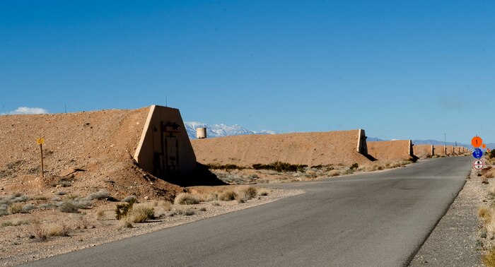 Earth covered munitions storage igloos line the road of the 57th Maintenance Squadron munitions storage area at Nellis Air Force Base, Nev. Feb. 11, 2013.  The igloos are used to store various munitions and are built to minimize the blast in case of accidental detonation. (U.S. Air Force photo by Tech. Sgt. Taylor Worley)