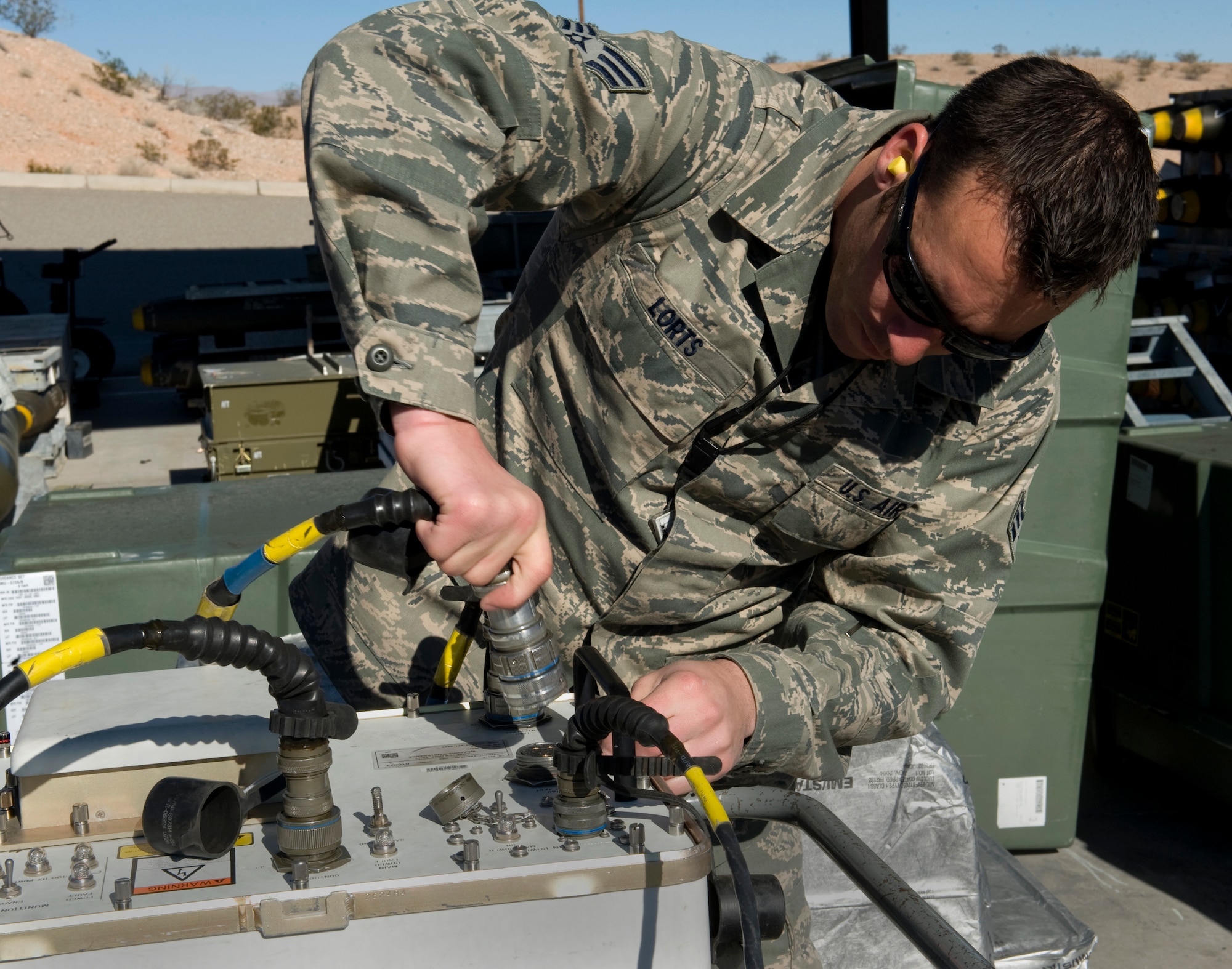 Senior Airman Joesph Lorts, 57th Maintenance Squadron munitions systems journeyman, prepares to test KMU-572A/B fin kits Feb. 11, 2013, at Nellis Air Force Base, Nev.  The kits convert gravity bombs to guided bombs making them more accurate. (U.S. Air Force photo by Tech. Sgt. Taylor Worley)