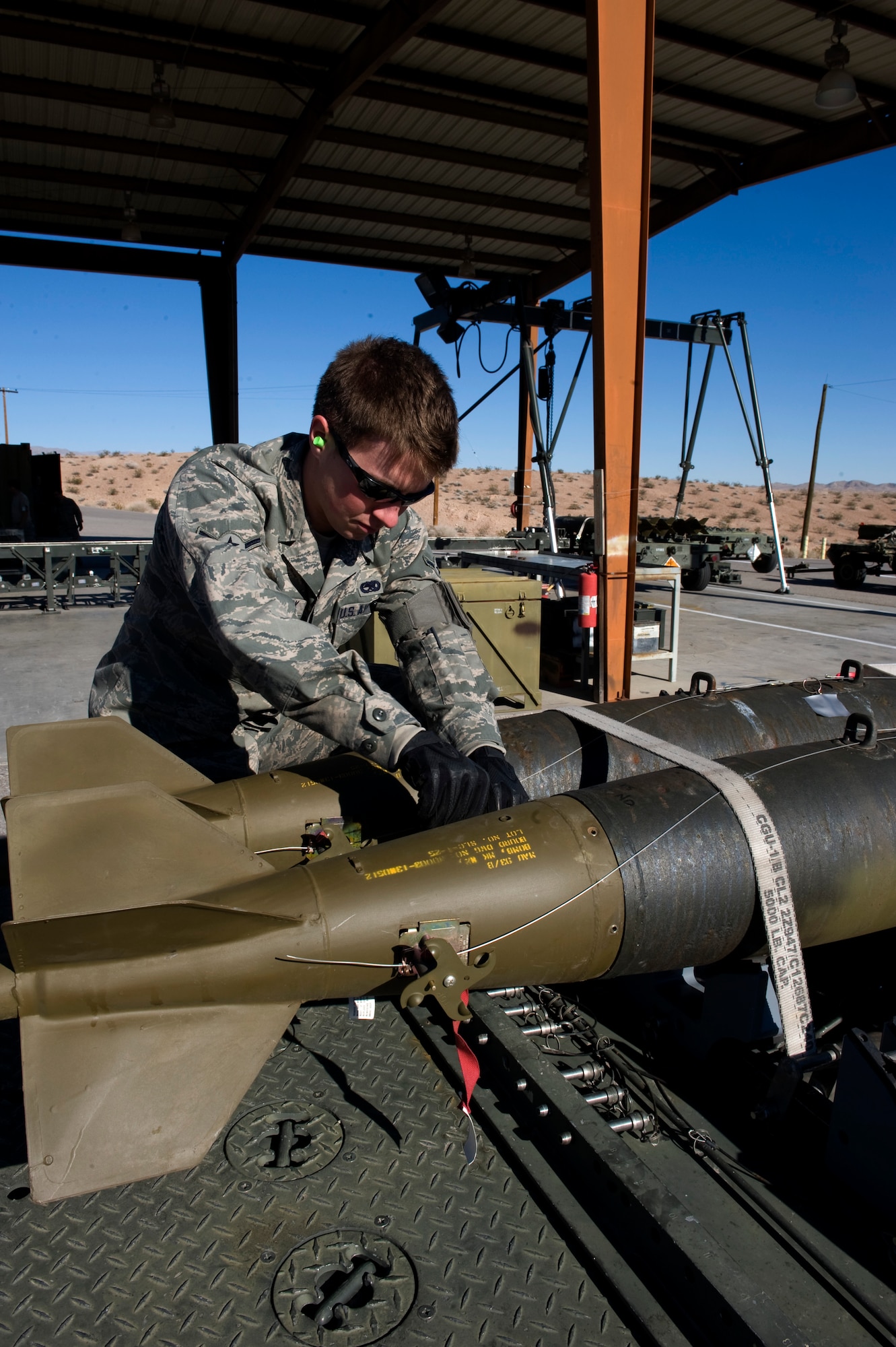 Airman Orion Fredrick, 57th Maintenance Squadron munitions systems apprentice, inspects a Mk-82 bomb during a post load inspection  Feb. 11, 2013, at Nellis Air Force Base, Nev. Munitions that are flown but not launched must have a post load inspection to insure serviceability prior to being loaded on another aircraft. (U.S. Air Force by Tech. Sgt. Taylor Worley)