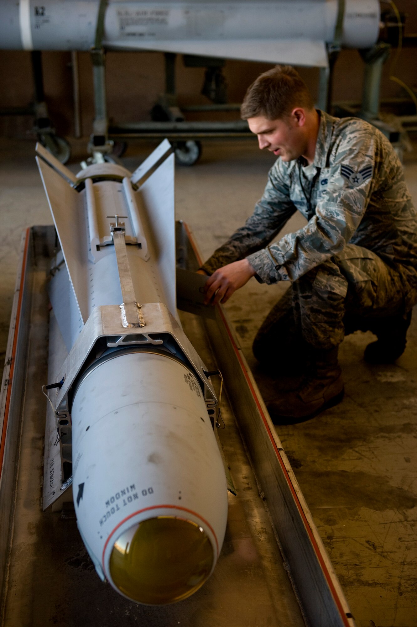 Senior Airman Joshua Schexnayder, a 57th Maintenance Squadron munitions systems journeyman, performs a post load inspection on an AGM-65 Feb. 7, 2013 at Nellis Air Force Base, Nev. Munitions that are flown but not launched must have a post load inspection to ensure serviceability prior to being loaded on another aircraft. (U.S. Air Force photo by Tech. Sgt. Taylor Worley)
