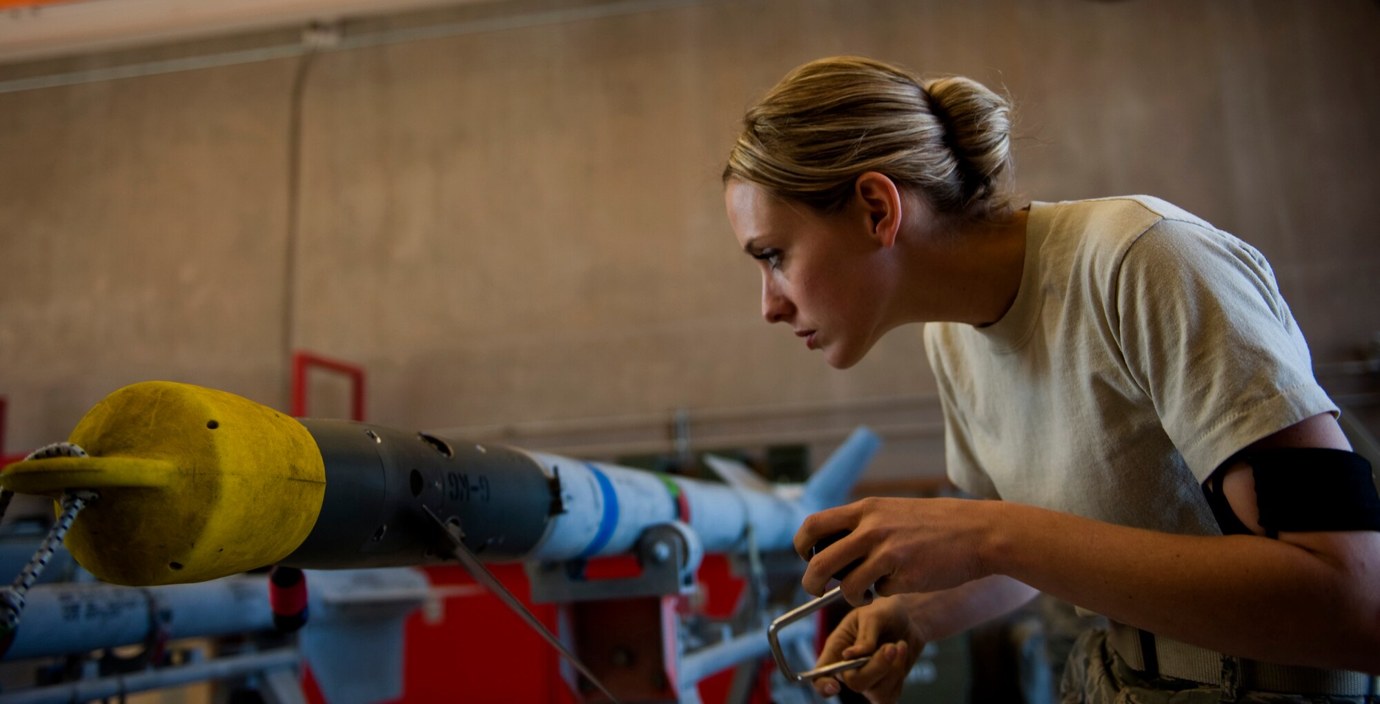 Staff Sgt. Brittney Benke, 57th Maintenance Squadron munitions systems craftsman, prepares to attach BSU-32 fins onto the guidance unit of a CATM 9M missile Feb. 7, 2013 at Nellis Air Force Base, Nev. Benke is assigned to the Precision Guided Munitions shop, building and maintaining  air-to-air missiles, air-to-ground missiles, and computer control groups for guided bombs. (U.S. Air Force photo by Tech. Sgt. Taylor Worley)