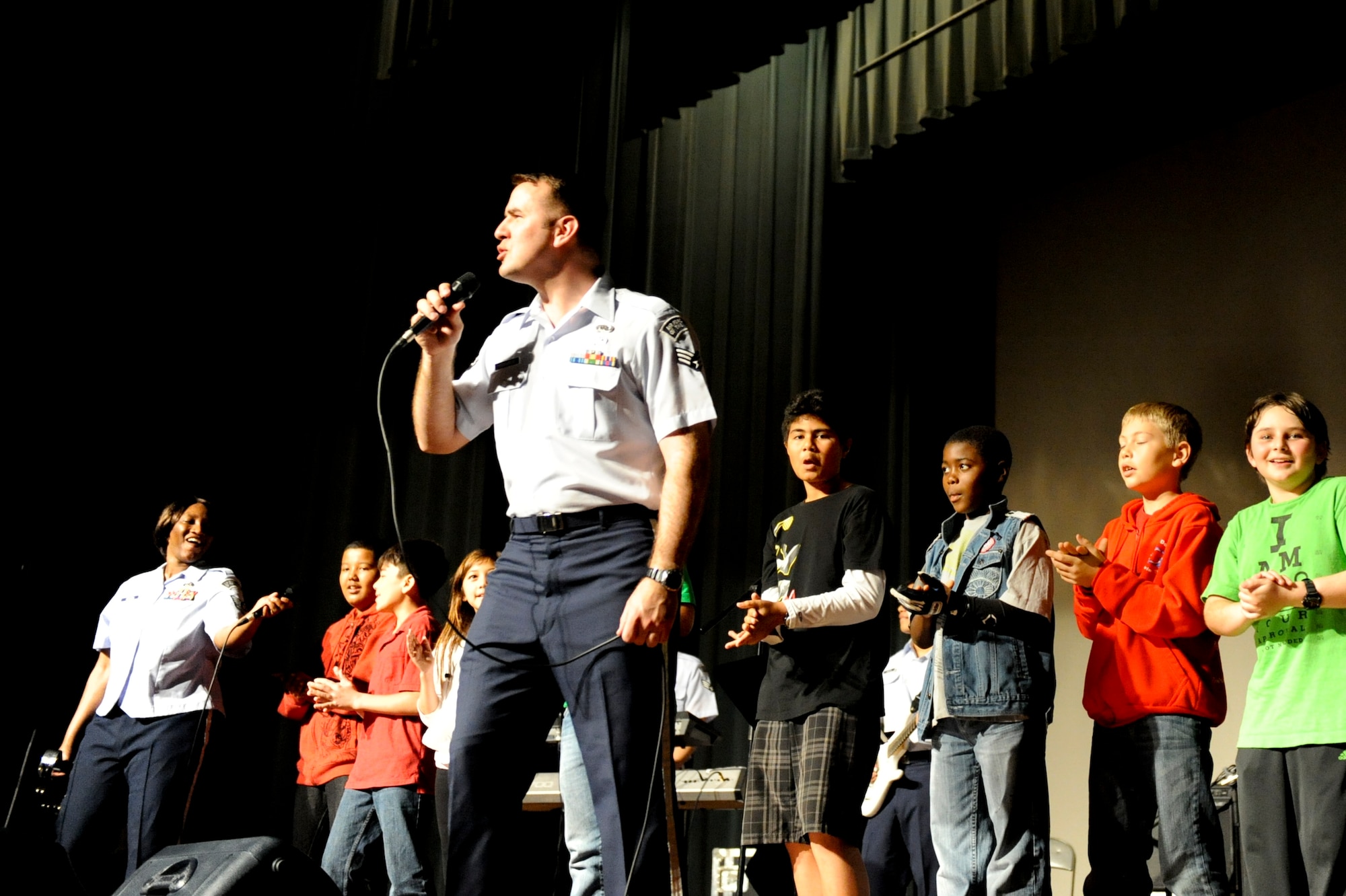 The Pacific Air Forces band, Pacific Trends, performs with a little help from the audience on Kadena Air Base, Japan, Feb. 7, 2013. The show was performed for more than 800 students from local military base schools. Later that evening the band performed again for all service members and their families. (U.S. Air Force photo/Airman 1st Class Brooke P. Doyle)
