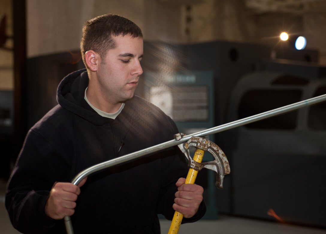 Airman 1st Class Alexander Price, 28th Civil Engineer Squadron electrical systems technician, uses a tool to bend conduit pipe at the South Dakota Air and Space Museum, Box Elder, S.D., Jan. 30, 2013. Price and other Airmen of the 28th CES Electric Shop are responsible for maintaining more than 328 buildings on and off Ellsworth Air Force Base. (U.S. Air Force photo by Airman 1st Class Alystria Maurer/Released)