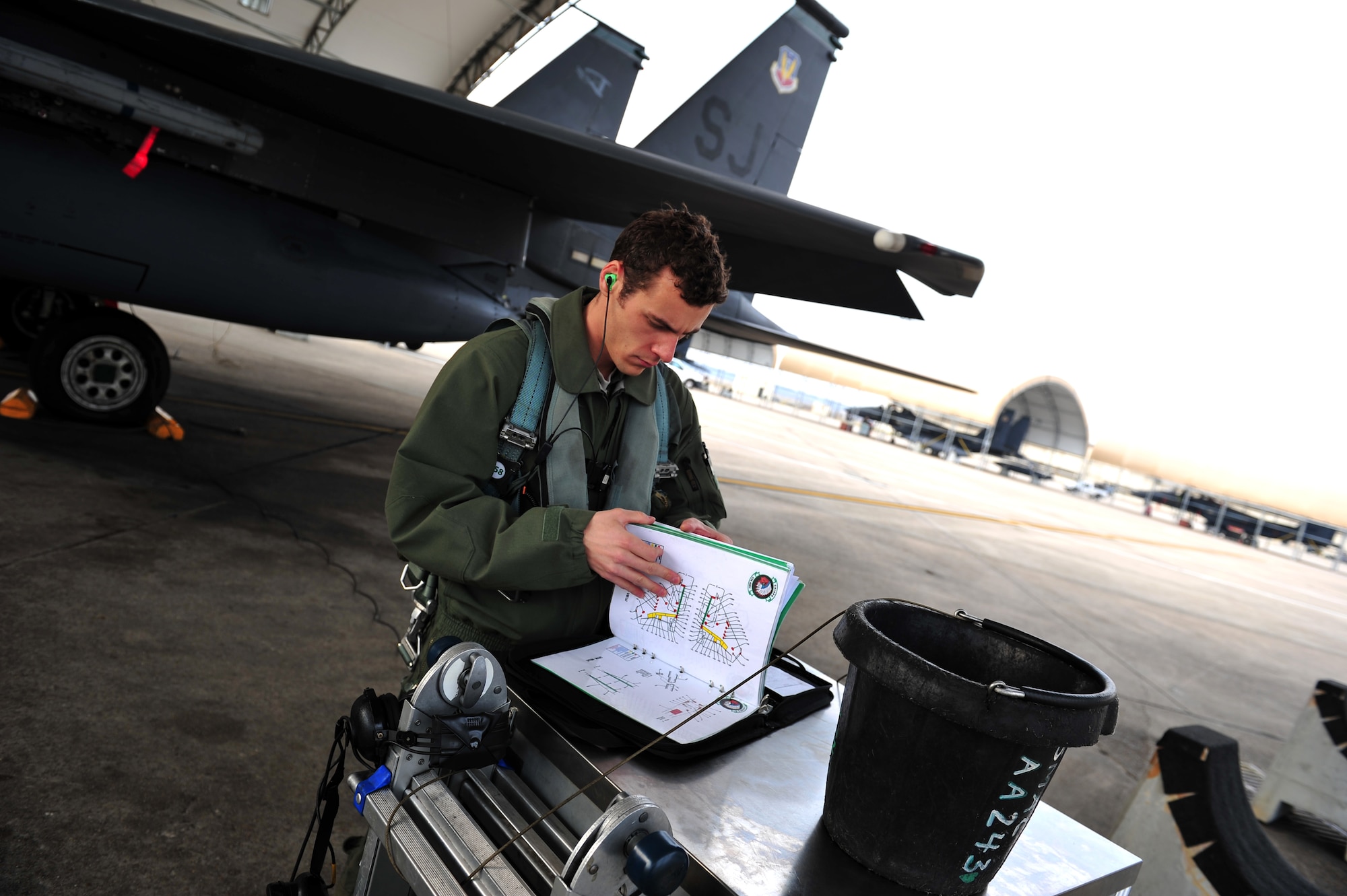 U.S. Air Force Capt. Justin Pavoni, 335th Fighter Squadron pilot, reviews pre-flight inspections manuals during exercise RAZOR TALON on Seymour Johnson Air Force Base, N.C., Feb. 7, 2013. RAZOR TALON is a monthly, large force exercise and joint-unit training opportunity to employ cutting edge operational concepts such as AirSea and Maritime Air Support on the Atlantic Coast. (U.S. Air Force photo by Staff Sgt. Andy M. Kin)