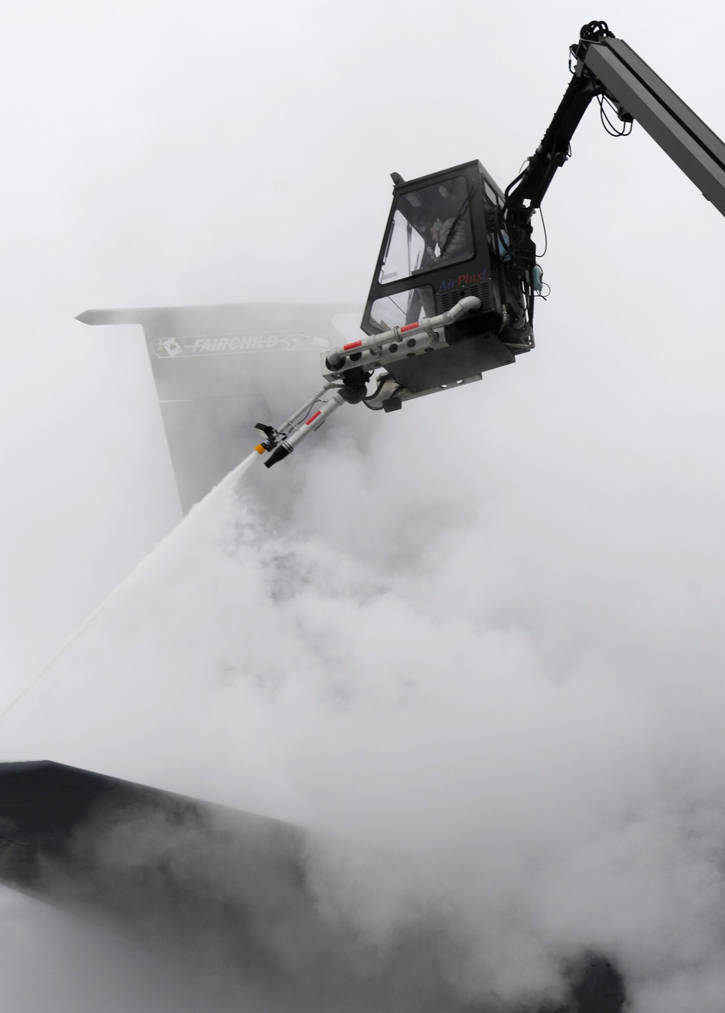 Staff Sgt. Aaron Wynhoff, 141st Aircraft Maintenance Squadron crew chief, sprays a KC-135 Stratotanker with de-icing fluid on the flight line at Fairchild Air Force Base, Wash., Jan. 24, 2013. The trucks used are capable of holding 1,640 gallons of de-icing fluid and 165 gallons of anti-ice. (U.S.  Air Force photo by Airman 1st Class Ryan Zeski)