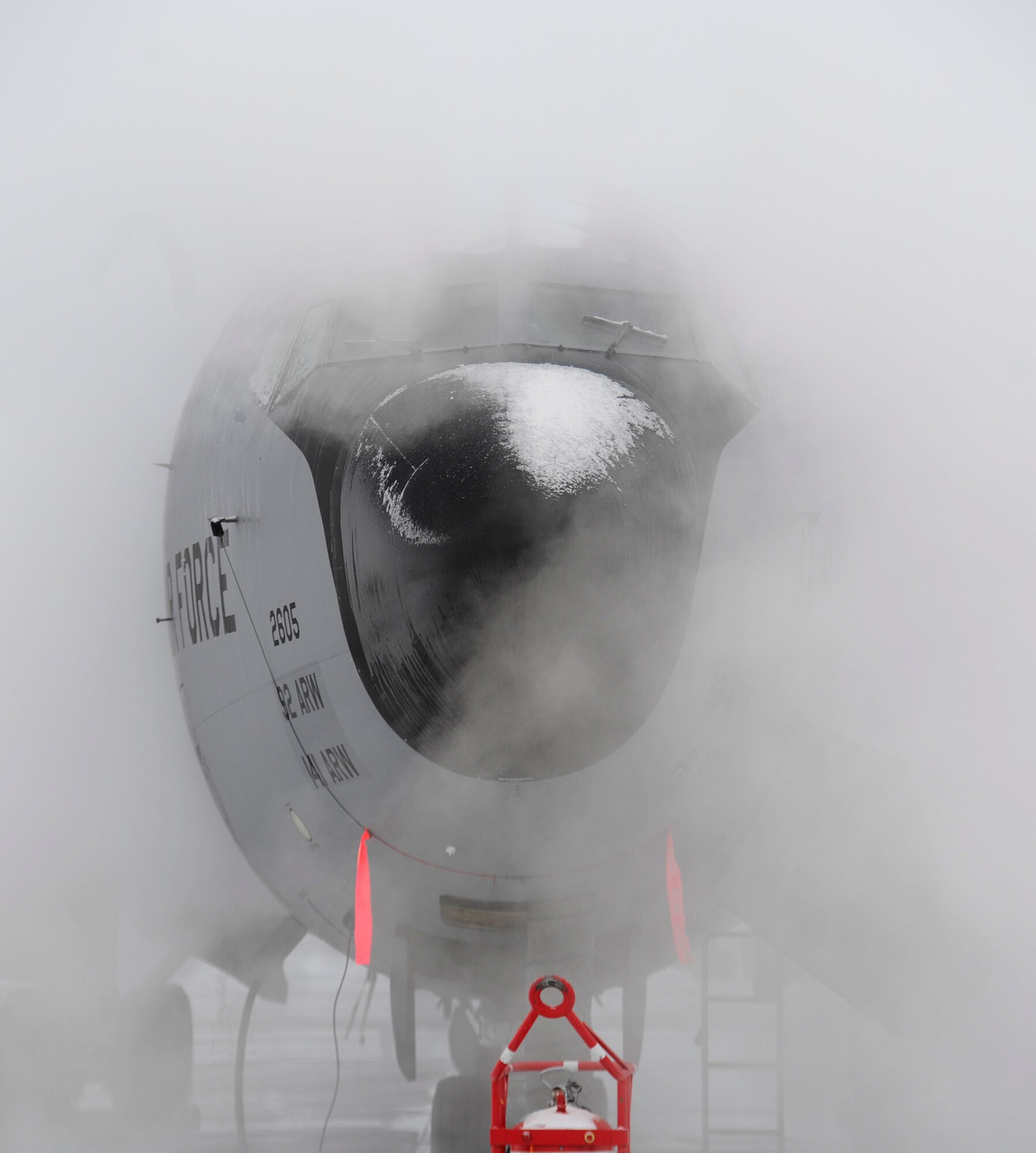 De-icing crews apply de-icier to a KC-135 Stratotanker on the flight line at Fairchild Air Force Base, Wash., Jan. 24, 2013. Since October de-icier has been applied to aircraft more than 400 times. (U.S. Air Force photo by Airman 1st Class Ryan Zeski)