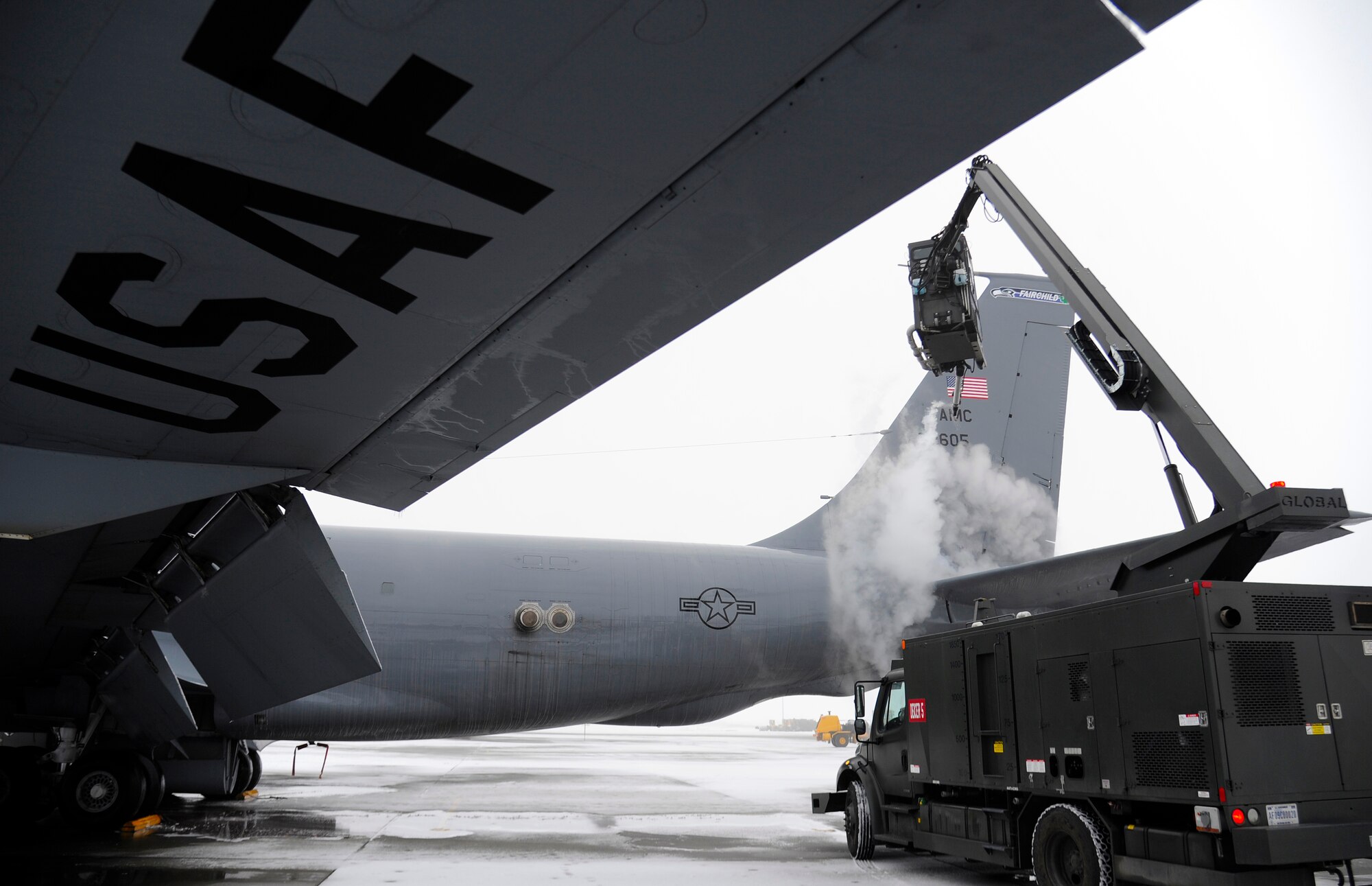 Staff Sgt. Aaron Wynhoff, 141st Aircraft Maintenance Squadron crew chief, applies de-icier to a KC-135 Stratotanker on the flight line at Fairchild Air Force Base, Wash., Jan. 24, 2013. Wynhoff is spraying the aircraft with chemicals that remove ice and prevent it from reforming during flight. (U.S.  Air Force photo by Airman 1st Class Ryan Zeski)