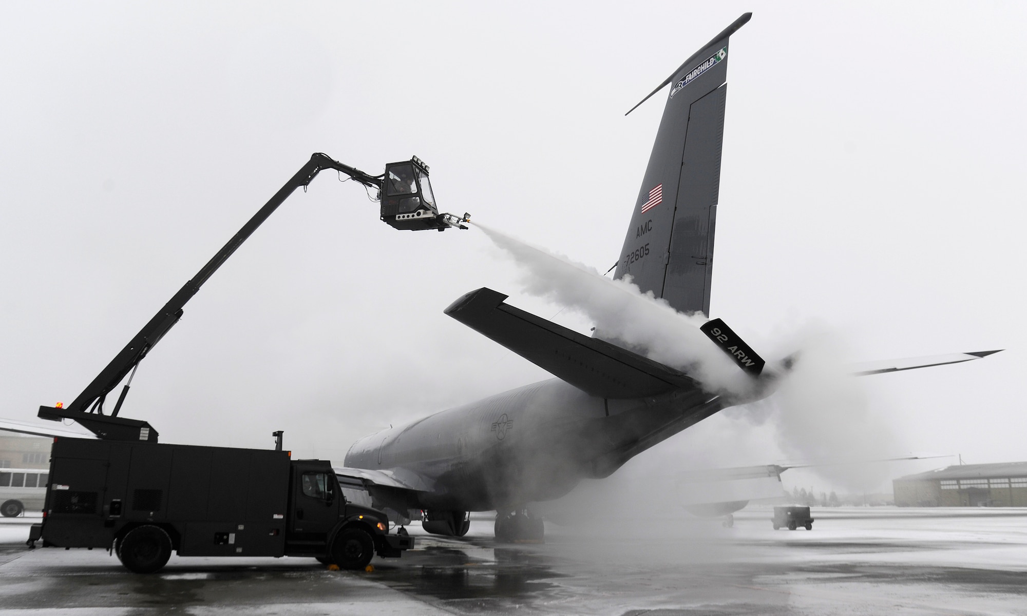 Staff Sgt. Aaron Wynhoff, 141st Aircraft Maintenance Squadron crew chief, de-ices a KC-135 Stratotanker on the flight line at Fairchild Air Force Base, Wash., Jan. 24, 2013. On average it costs $4,000 to de-ice an aircraft. (U.S.  Air Force photo by Airman 1st Class Ryan Zeski)