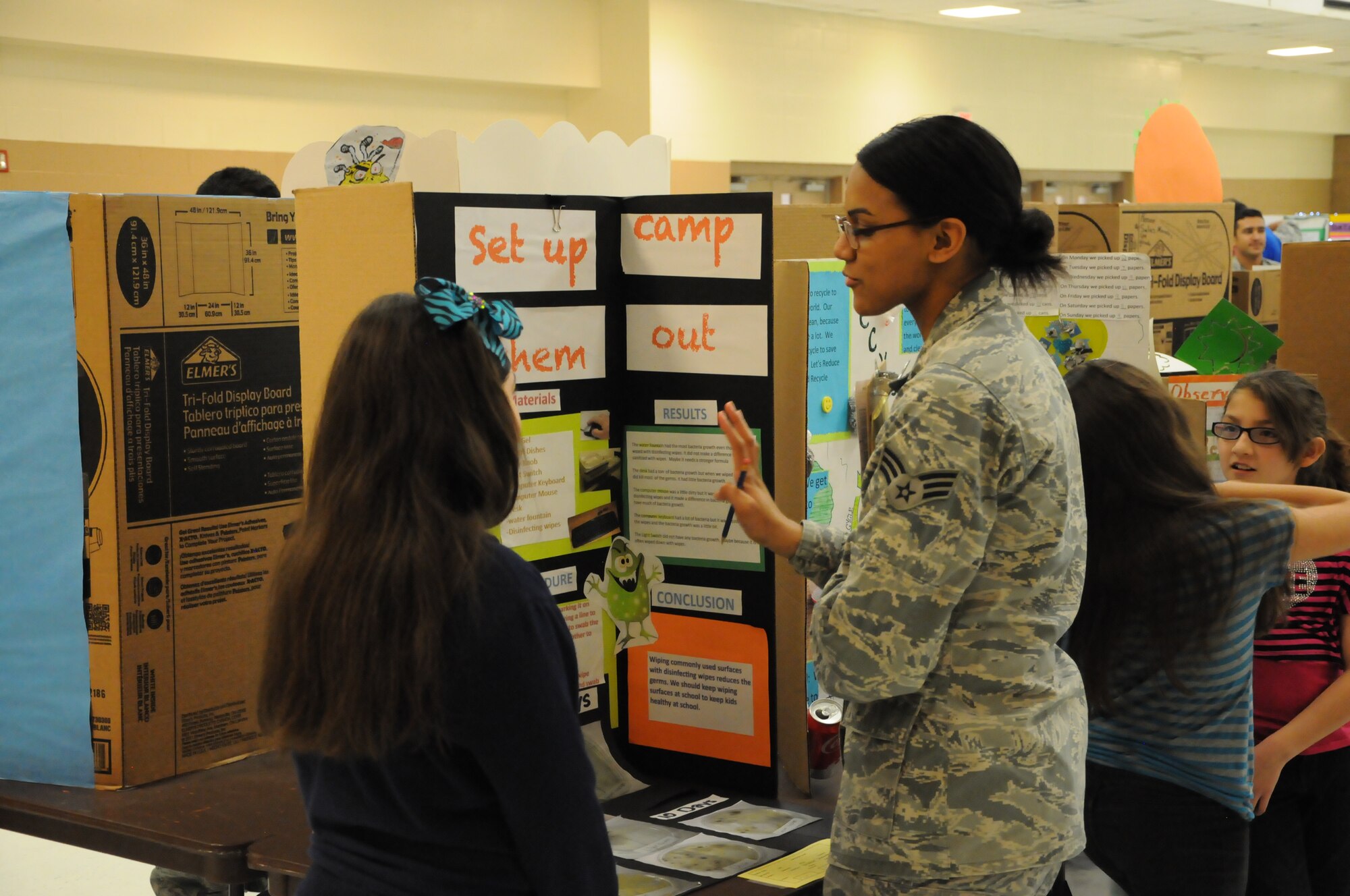 Senior Airman Chloe Ullah, 47th Medical Group public health technician, provides feedback to an elementary student for the elementary schools’ district science fair at the Del Rio Civic Center Del Rio, Texas, Feb. 7, 2013. Volunteers from Laughlin made up more than half of the judges for the 148 science fair projects and the little less than 200 children participating in the San Felipe Del Rio Consolidated Independent School District, district science fair. (U.S. Air Force photo/2nd Lt. David Tart)