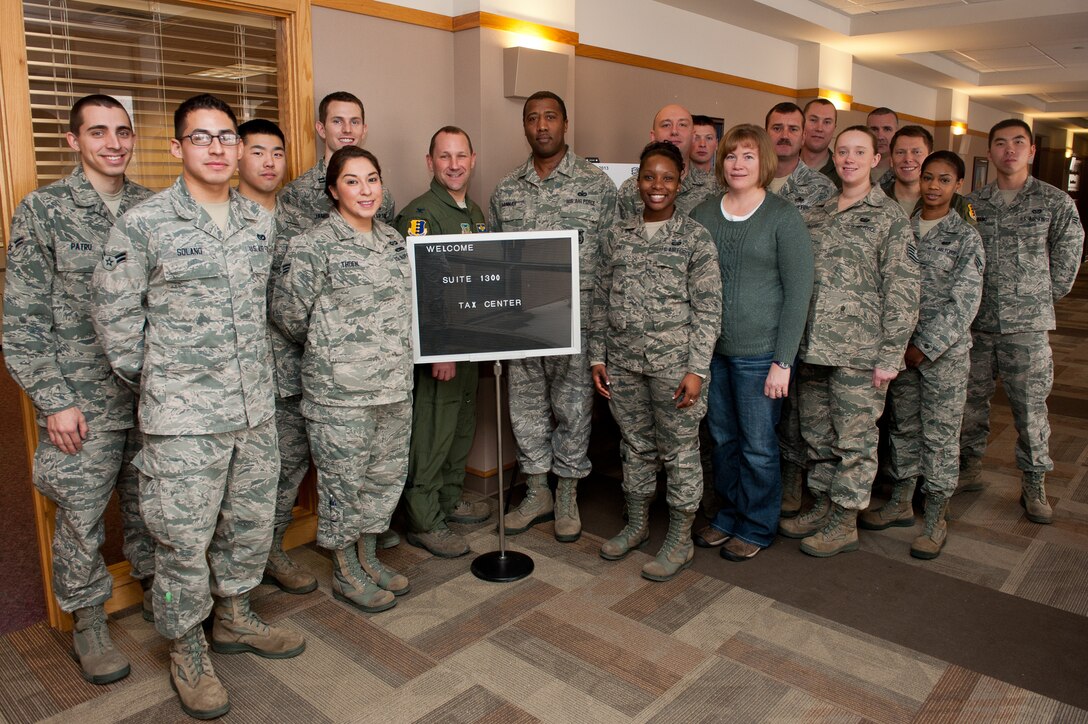 Col. Gentry Boswell, 28th Bomb Wing vice commander (center), congratulates volunteers for the base tax center during its grand opening at the Rushmore Center on Ellsworth Air Force Base, S.D., Feb. 1, 2013. Active-duty Airmen, retirees and family members of both can now file their 2012 taxes for free at the base tax center. For more information or to make an appointment, call the tax center at (605) 385-2329. 