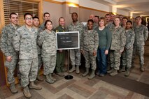Col. Gentry Boswell, 28th Bomb Wing vice commander (center), congratulates volunteers for the base tax center during its grand opening at the Rushmore Center on Ellsworth Air Force Base, S.D., Feb. 1, 2013. Active-duty Airmen, retirees and family members of both can now file their 2012 taxes for free at the base tax center. For more information or to make an appointment, call the tax center at (605) 385-2329. 