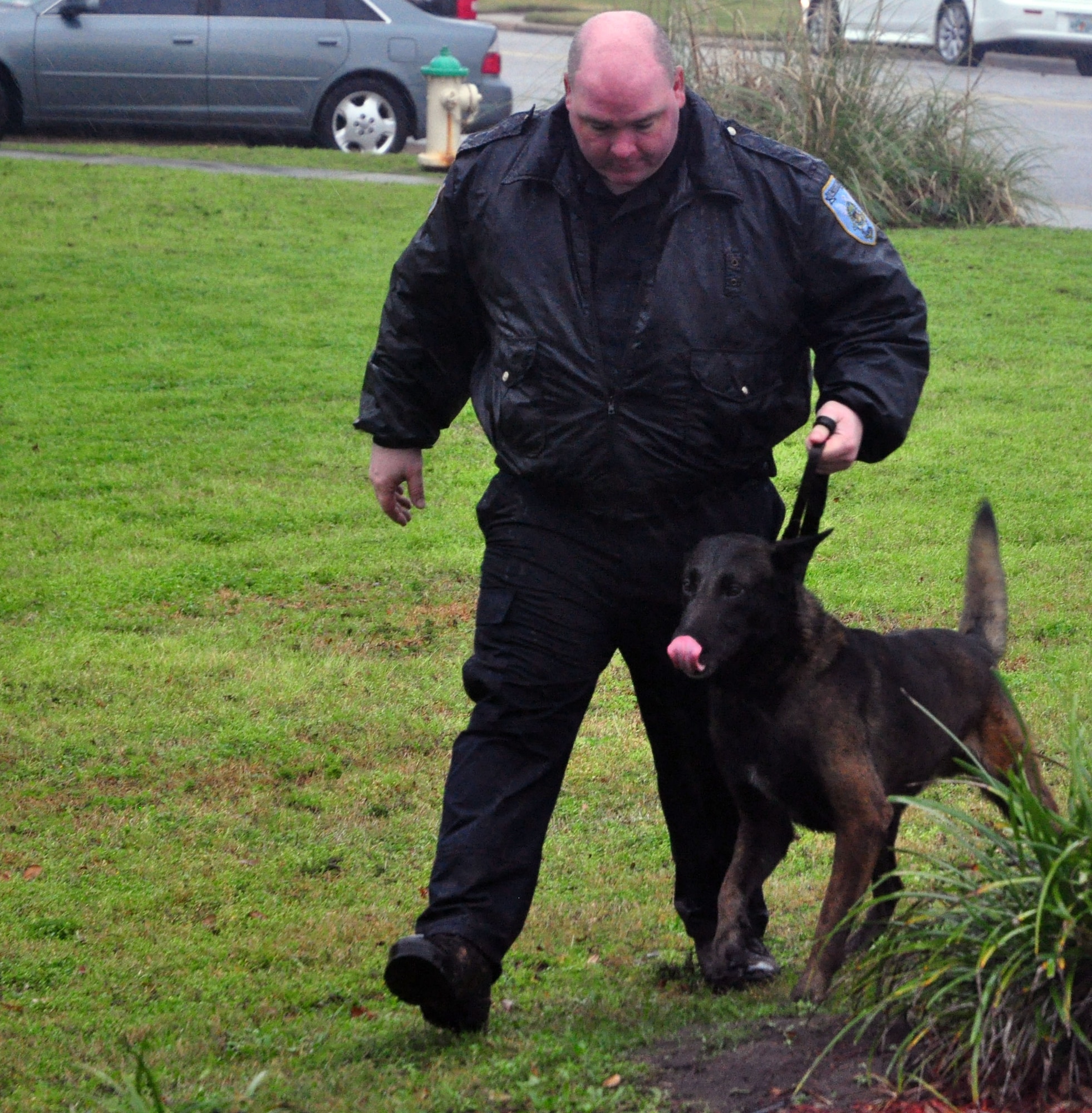 Jason F. Gleason, Panama City Beach Police Department corporal, leads Argo, his canine companion, into the Tyndall base chapel Feb. 7 as part of a narcotics working dog seminar attended by local and base authorities. (U.S. Air Force photo by Airman 1st Class Alex Echols)
