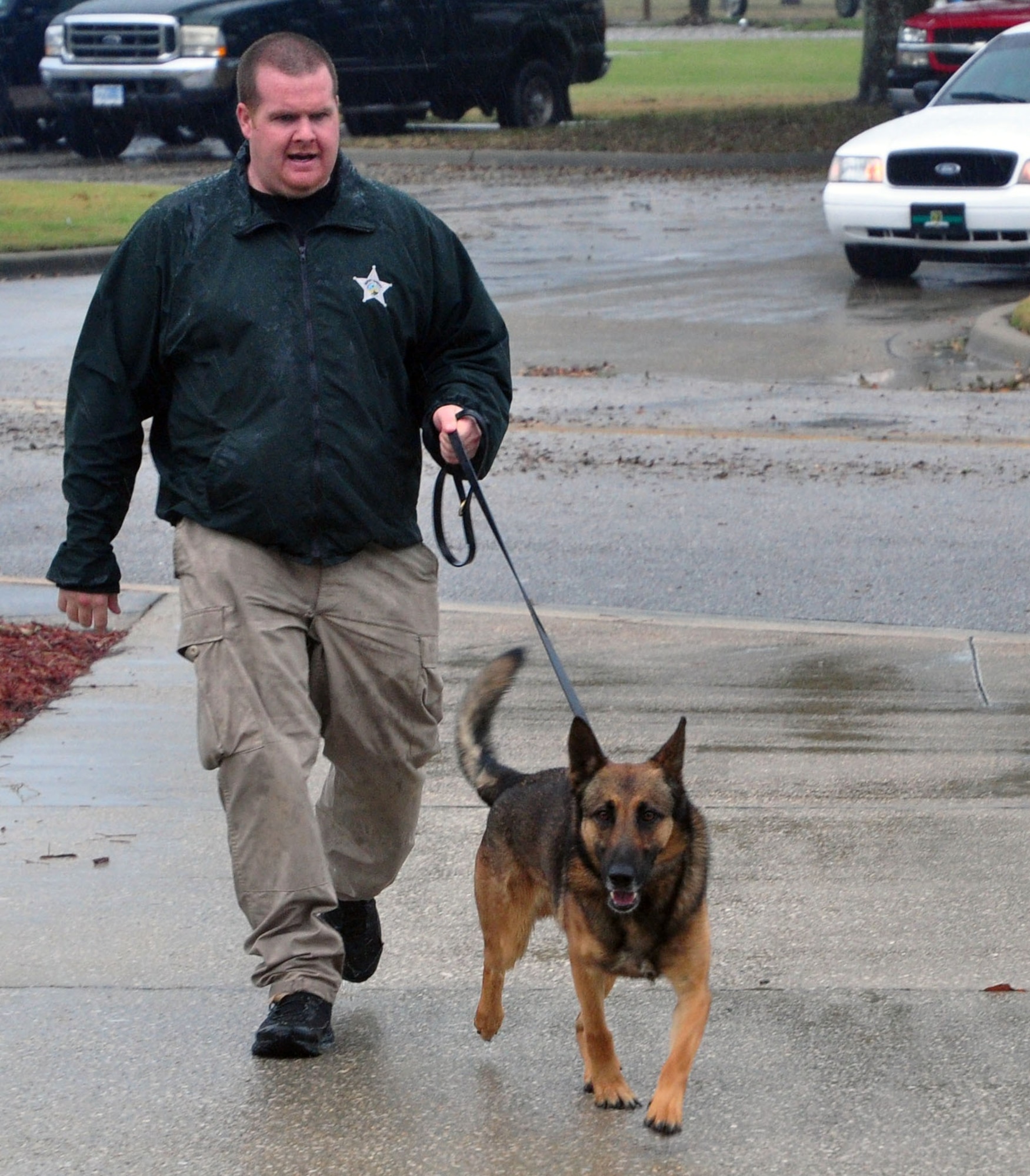Andrew Longo, Washington County Sheriff’s Office deputy, leads Risko, his canine companion, into the Tyndall base chapel Feb. 7 as part of a narcotics working dog seminar attended by local and base authorities. (U.S. Air Force photo by Airman 1st Class Alex Echols)