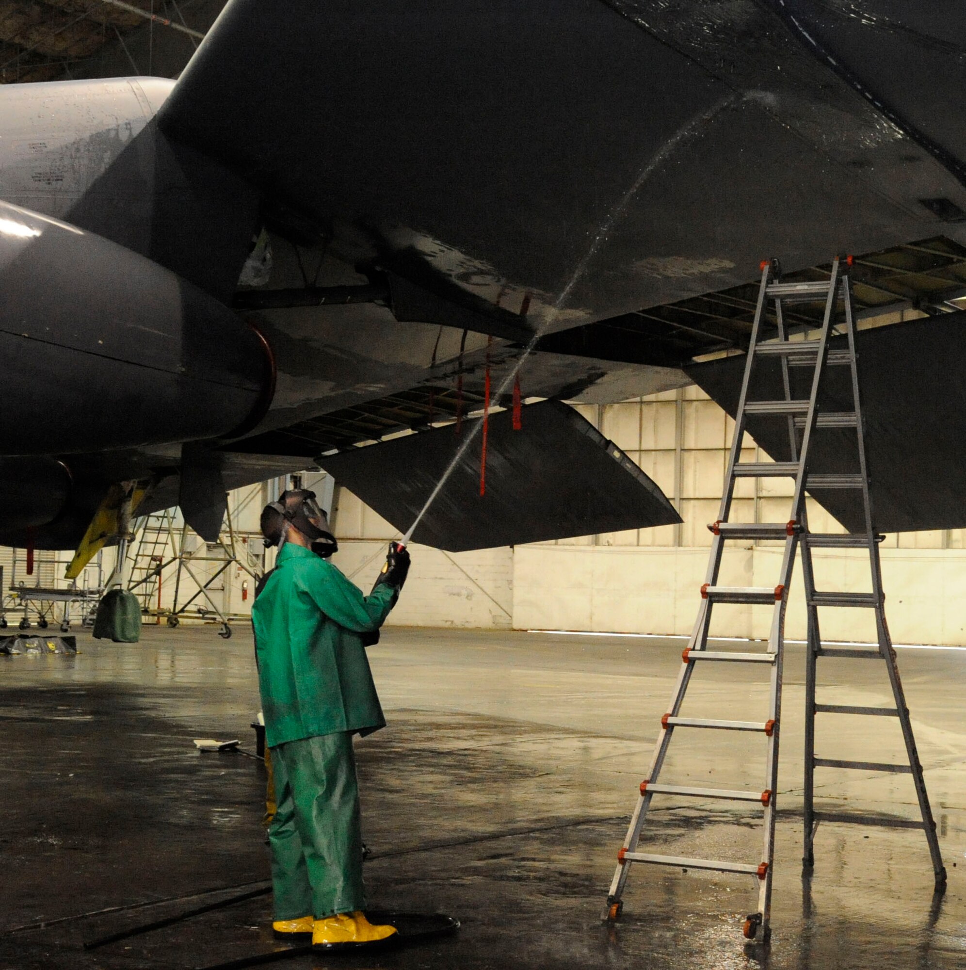 Airman Austin West, 2nd Aircraft Mainetenance Squadron, rinses a pod mount on a B-52H Stratofortress prior to a corrosion inspection on Barksdale Air Force Base, La., Feb. 12. Cleaning the aircraft of corrosion involves in-depth cleaning of areas where moisture gathers and applying a solution known as a corrosion preventative compound, which helps to prevent or delay corrosion from forming. (U.S. Air Force photo/Airman 1st Class Andrew Moua)