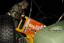 Airman 1st Class Joseph Pandolfo, 8th Communications Squadron, pulls a stanchion from a Humvee during exercise Beverly Bulldog 13-2 at Kunsan Air Base, Republic of Korea, Feb. 12, 2013. The stanchions list the necessary MOPP level precautions for Airmen as they enter or leave a chemical zone. (U.S. Air Force photo by Senior Airman Marcus Morris/Released)