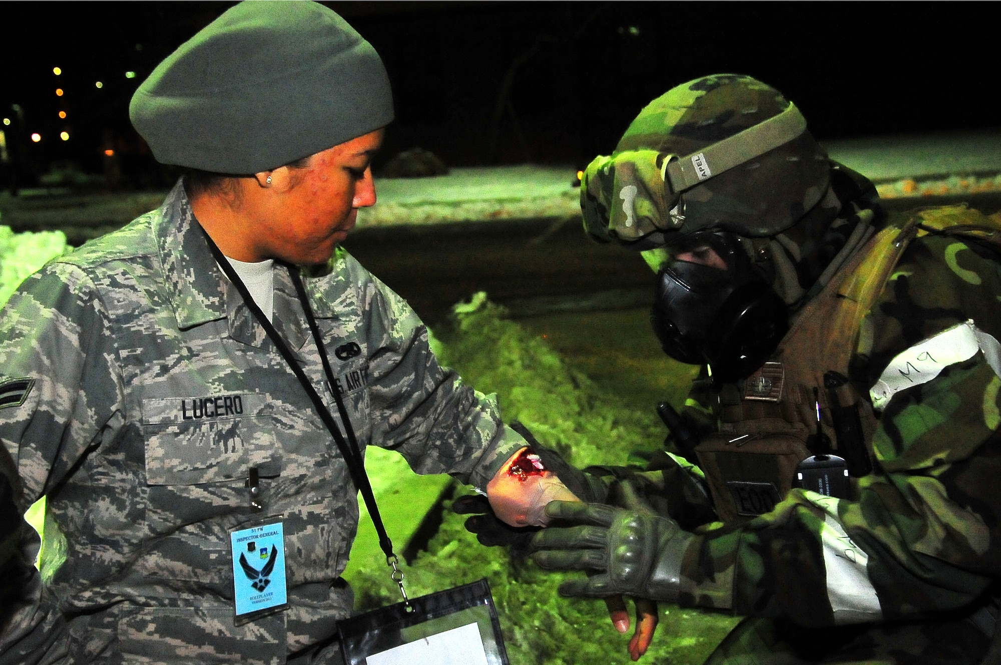 Airman 1st Class Shawn Hewitt, 51st Civil Engineer Squadron Explosive Ordinance Disposal Flight technician, analyzes the injury on Airman 1st Class Devanee Lucero, 51st Munitions Squadron munitions technician, on Osan Air Base, Republic of Korea, Feb.13, 2013.  EOD members were the first to respond when they happen to drive by the mass casualty site. (U.S. Air Force photo/Staff Sgt. Emerson Nuñez)