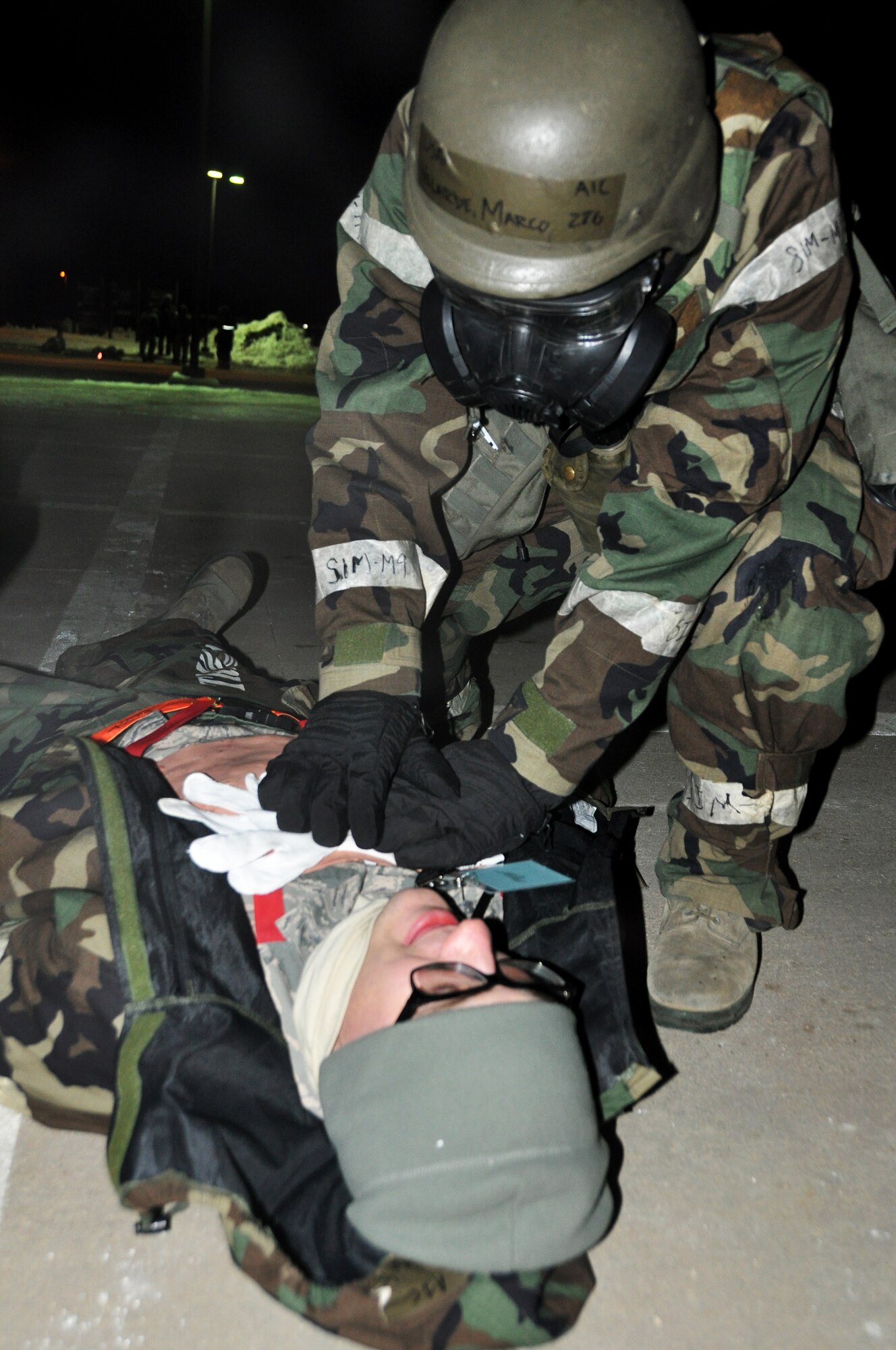 Airman 1st Class Marco Velardebanuelos, 51st Civil Engineer Squadron explosive ordnance disposal member, applies pressure to a sucking chest wound of a simulated casualty during operation readiness exercise Beverly Bulldog 13-02 Feb. 13, 2013. Osan Airmen practice operational readiness exercises to maintain proficiency for wartime conditions. (U.S. Air Force photo/Senior Airman Kristina Overton)