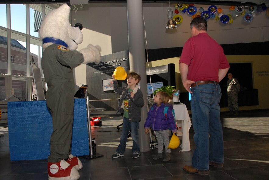 Landon Kegley and his sister Ella meet Saber Dog during the 178th Fighter Wing Saber Kids program at the Hollinbeck-Bayley Creative Arts Center in Springfield, Ohio February 9, 2013. The Saber Kids program provides child identification cards for families, and is a crucial link in public relations between the members of the Springfield Air National Guard and its surrounding communities. 