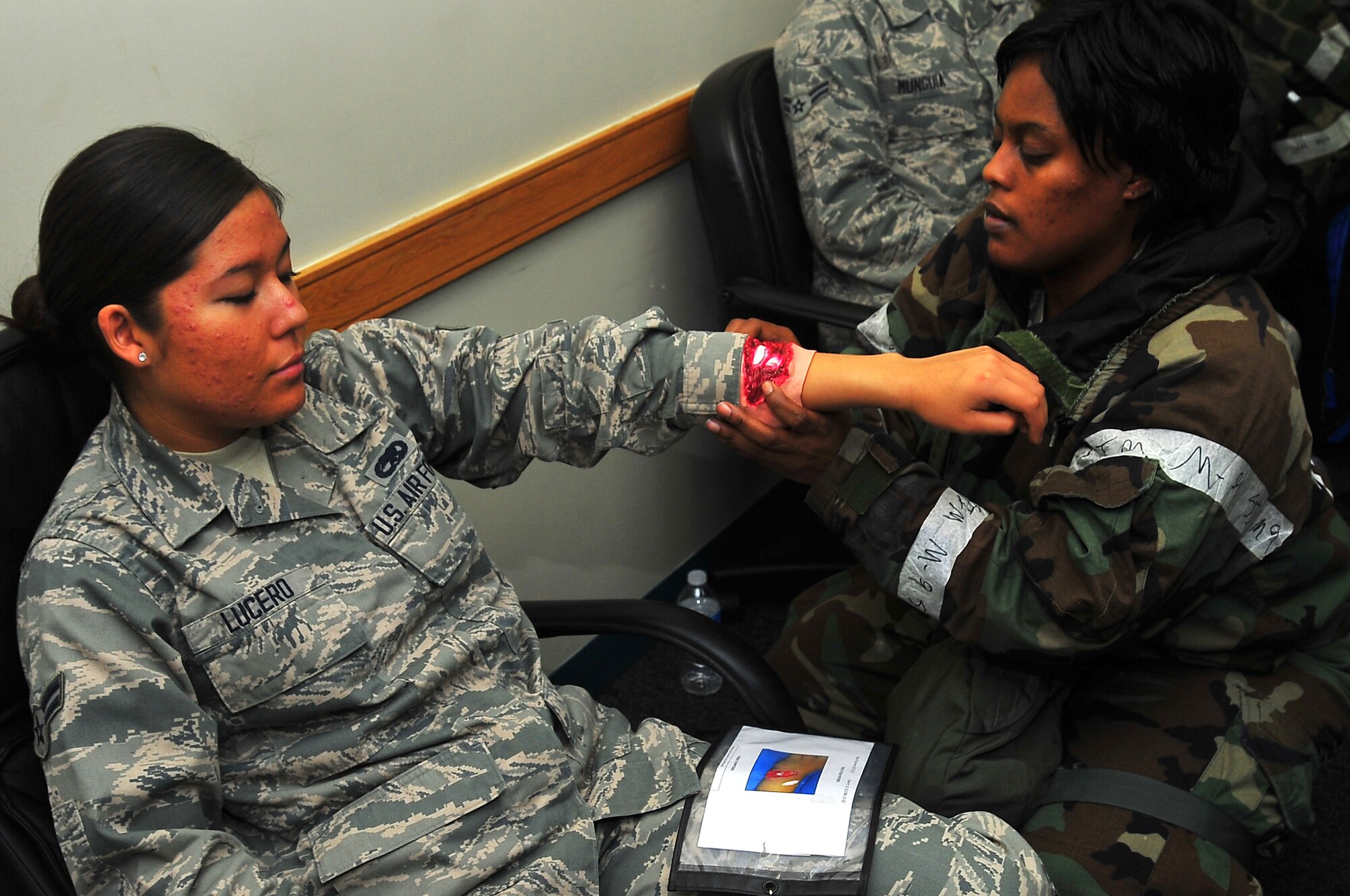 Major Charnell Smith, 51st Medical Support Squadron member, applies moulage to  Airman 1st Class Devanee Lucero, 51st Munitions Squadron munitions technician, in order to simulate an arm injury before a mass casualty simulation for operation readiness exercise Beverly Bulldog 13-02 in building 1097 on Osan Air Base, Republic of Korea, Feb. 13, 2013.  Participants exercised the ability to respond to a mojor incident at locations on and off base.  Moulage adds realism to scenarios encountered by first responders. (U.S. Air Force photo/Staff Sgt. Emerson Nuñez)