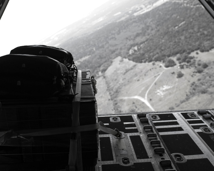 A cargo bundle rigged for a low-cost-low-altitude airdrop is positioned on a 317th Airlift Group C-130J Feb. 7, 2013, at Fort Hood, Texas. The LCLA airdrops are a special container delivery system, designed to be used and discarded rather than turned in and reused.  This method saves the receiver trouble, and the low altitude helps with accuracy and staying under the radar of the enemy. (U.S. Air Force photo by Airman 1st Class Kylsee Wisseman/Released)