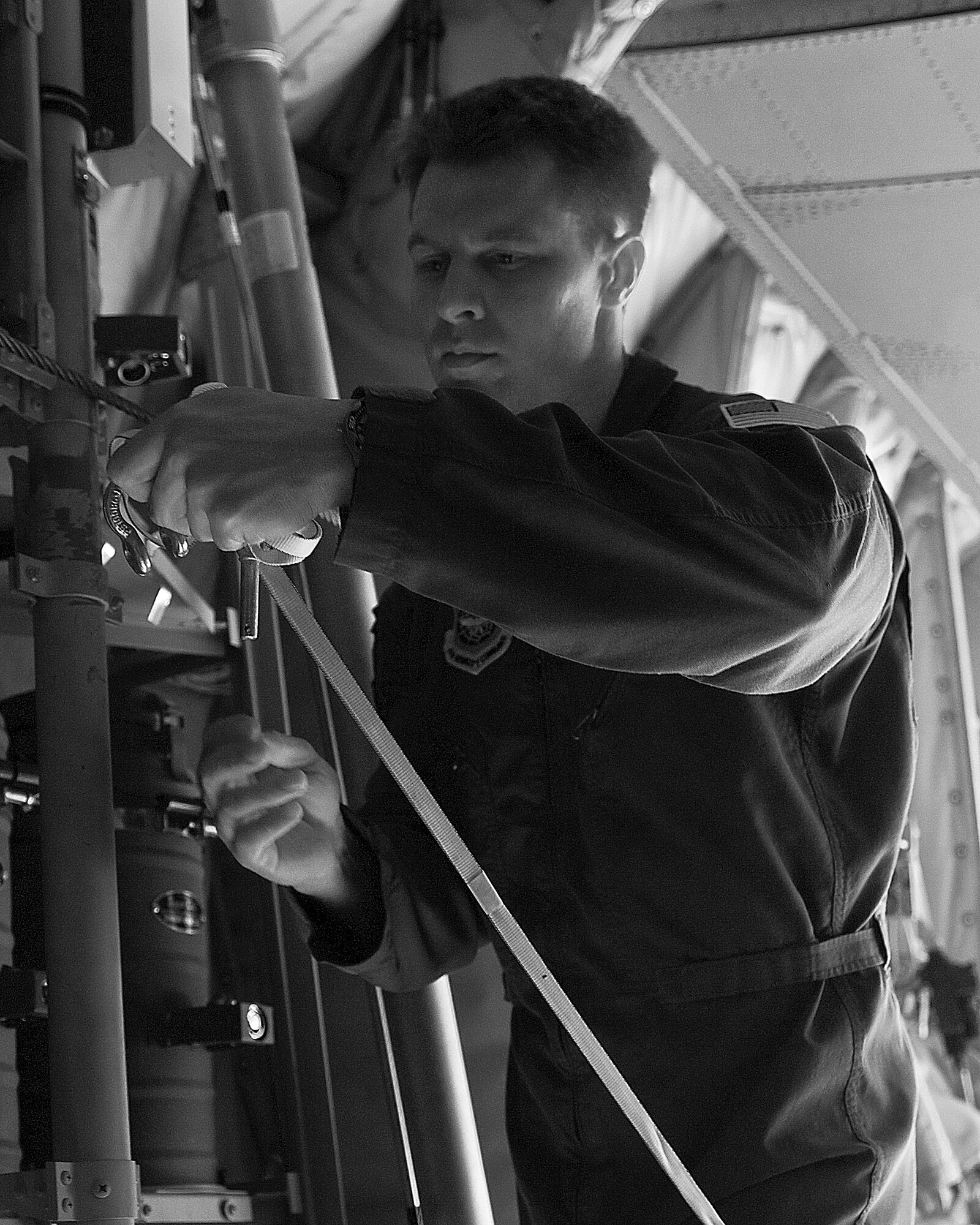 Tech. Sgt. Lee Deaver, 39th Airlift Squadron, secures a low-cost-low-altitude bundle for takeoff during a training exercise Feb. 7, 2013, at Fort Hood, Texas. The LCLA airdrops are a special container delivery system, designed to be used and discarded rather than turned in and reused.  This method saves the receiver trouble, and the low altitude helps with accuracy and staying under the radar of the enemy. (U.S. Air Force photo by Airman 1st Class Kylsee Wisseman/Released)
