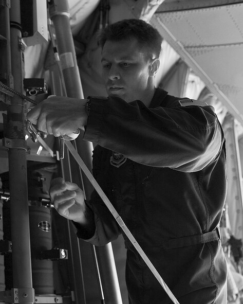 Tech. Sgt. Lee Deaver, 39th Airlift Squadron, secures a low-cost-low-altitude bundle for takeoff during a training exercise Feb. 7, 2013, at Fort Hood, Texas. The LCLA airdrops are a special container delivery system, designed to be used and discarded rather than turned in and reused.  This method saves the receiver trouble, and the low altitude helps with accuracy and staying under the radar of the enemy. (U.S. Air Force photo by Airman 1st Class Kylsee Wisseman/Released)