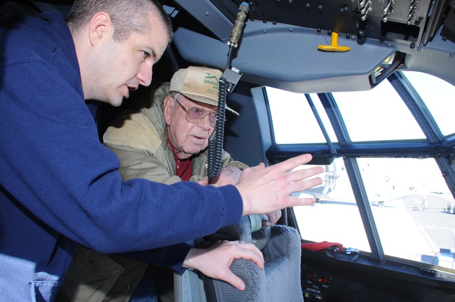 Maj. Eric Lipp, 415th Special Operations Squadron pilot, briefs World War II veteran Jack Gallette in the cockpit of an HC/MC-130J on the flightline Feb. 1 at Kirtland AFB, N.M.