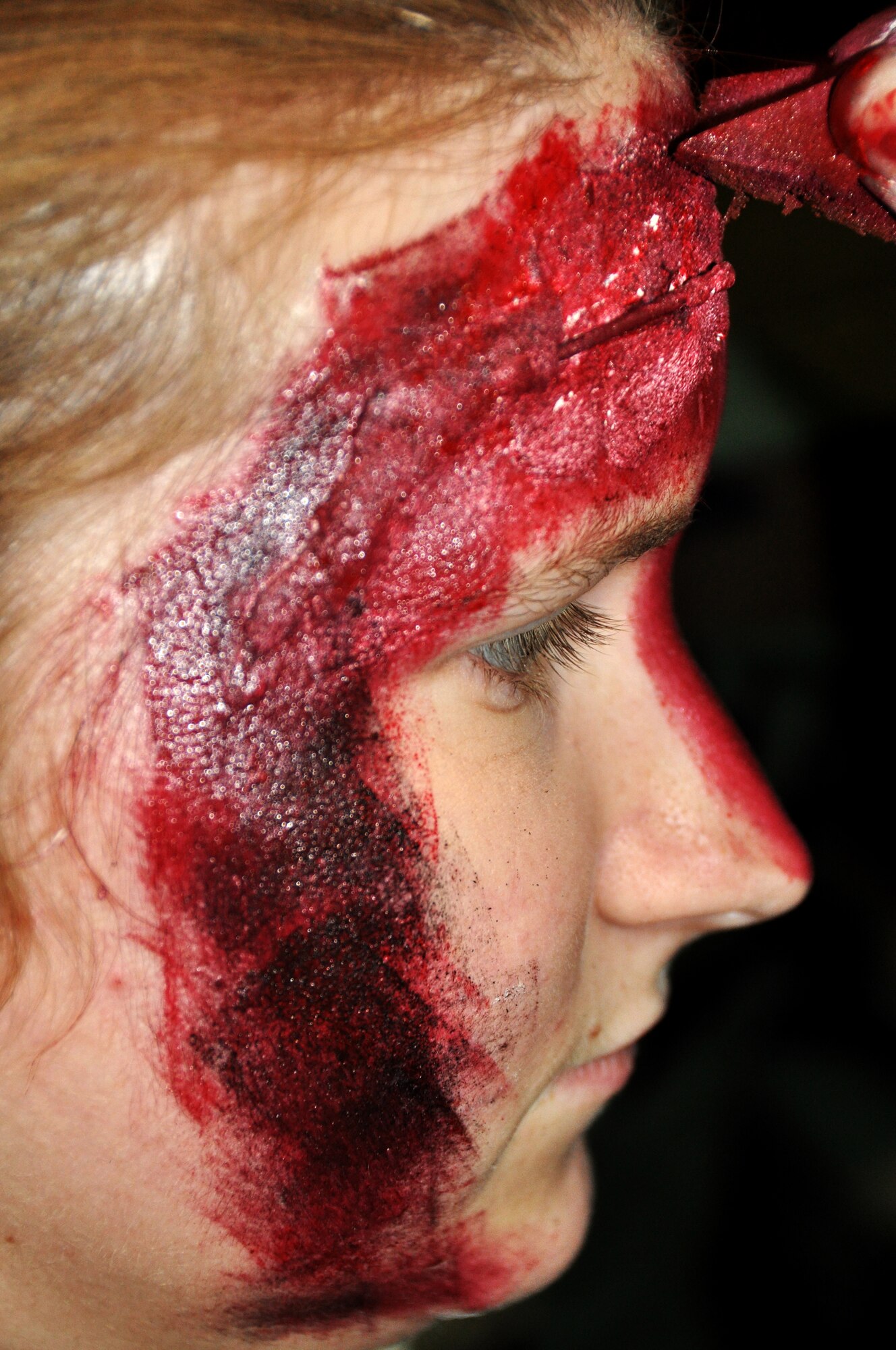 Senior Airman Christine Newman, 51st Force Support Squadron food service apprentice, acts as a role player for a mass casuality simulation during Beverly Bulldog 13-02, Feb. 13, 2013. Newman was injured in a simulated explosion and had shrapnel protruding from her face. (U.S. Air Force photo/Senior Airman Kristina Overton)
