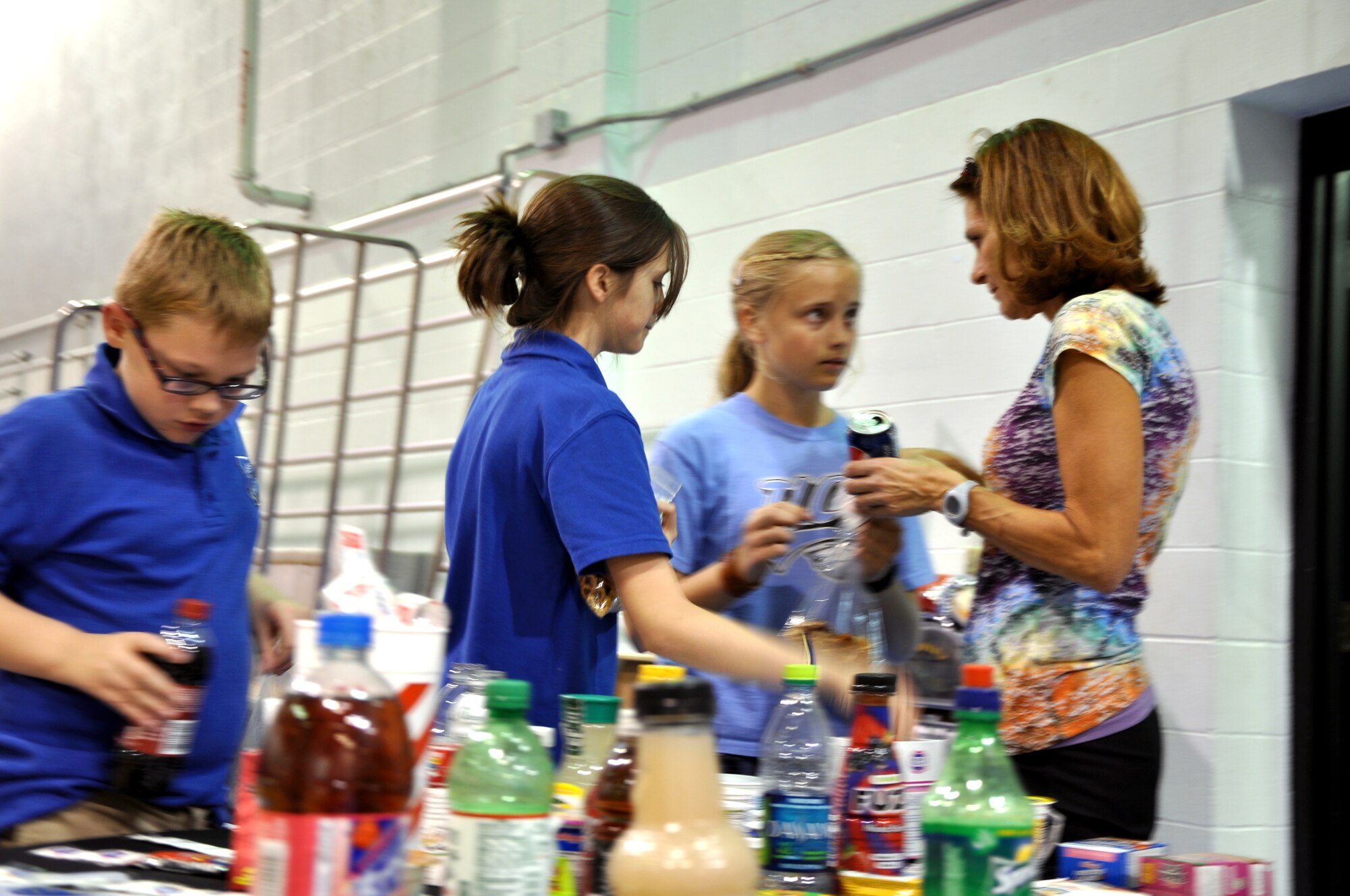 GOODFELLOW AIR FORCE BASE, Texas—Kathy Viau, 17th Medical Group dietitian, shows youths how much sugar is in common snack foods and drinks during the fifth annual Kids’ Fun Day at the Little League baseball field, Feb. 8. More than 100 children participated in the health awareness event. (U.S. Air Force photo/Airman Jessica Keith) 