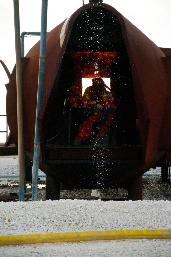 A member of the Del Rio Fire Department extinguishes a simulated fire in the fuselage of an aircraft mock-up during a live fire exercise here Feb. 11, 2013. The exercise, which included both Laughlin and Del Rio Fire Departments, was designed to help Del Rio firefighters maintain their currencies while training alongside Laughlin’s firefighters. (U.S. Air Force photo/2nd Lt. Evan M. Ross)