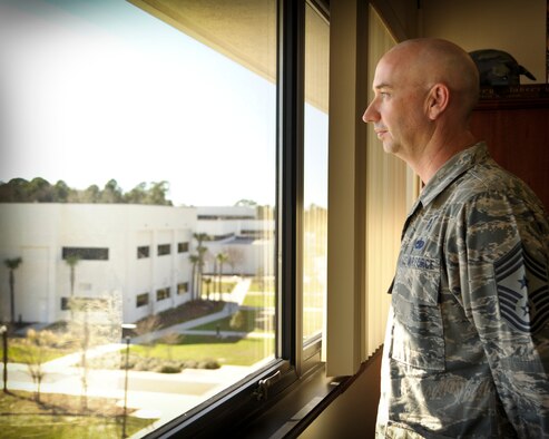 Chief Master Sgt. Jeffery Maberry, command chief of 1st Special Operations Wing gazes out his office window upon the base at Hurlburt field, Fla., Feb. 7, 2013.  Throughout his 25-year career as an enlisted member of the Air Force, Maberry held a broad spectrum of jobs and positions that ultimately guided his path to becoming a command chief of 1 SOW.  Maberry is no stranger to working closely with Airmen, as a third or more of his career has been spent as a first sergeant, always carrying his mantra, “know your Airmen.” (U.S. Air Force photo/Senior Airman Krystal Garrett)
