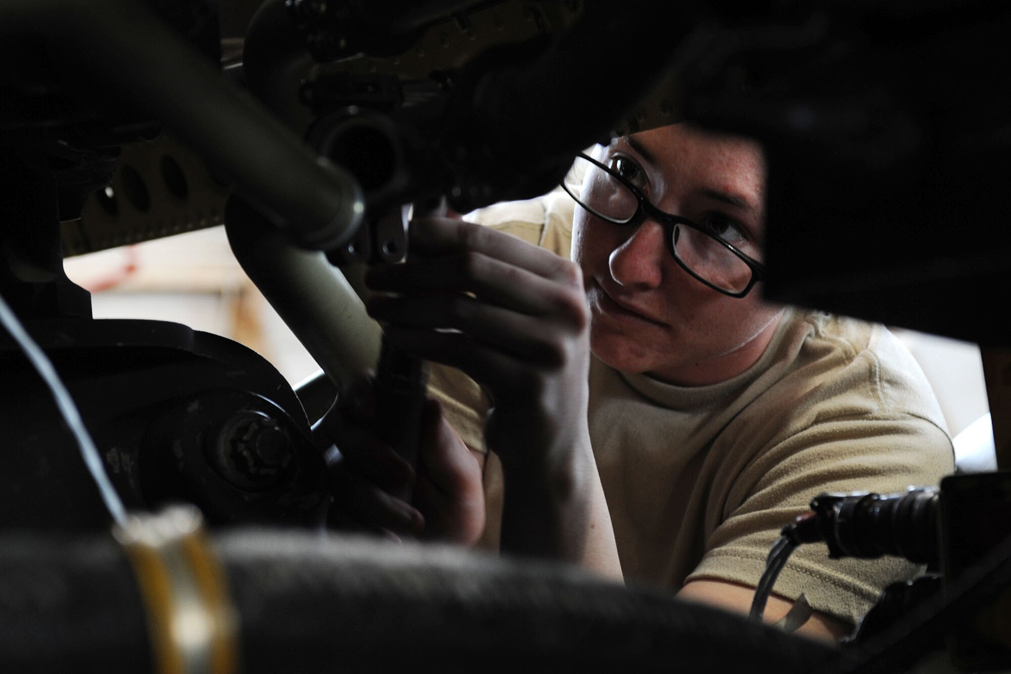 U.S. Army Pvt. Sarah Phinney, an Advanced Individual Training student assigned to B Company, 1st Battalion, 210th Aviation Regiment, performs maintenance on an AH-64 Apache at Fort Eustis, Va., Jan. 30, 2013. Each company – A, B, and C - trains enlisted Soldiers in a specific airframe or skill as part of their AIT requirements. (U.S. Air Force photo by Staff Sgt. Ashley Hawkins/Released)