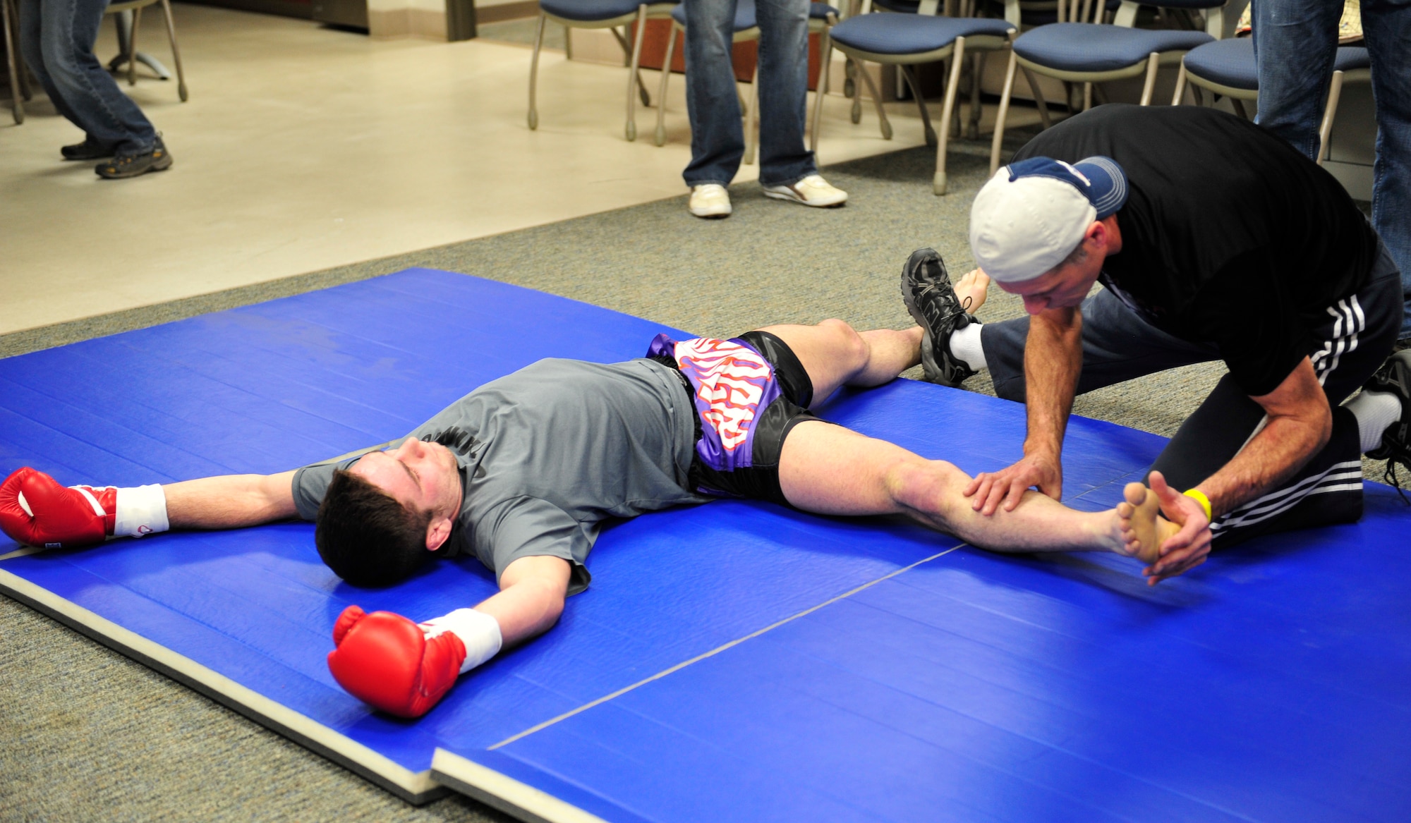 Mixed martial artist James Nakashima stretches before his fight, Feb. 9, 2013 in a back room of the Buckley Air Force Base Fitness Center. Nakashima was victorious over Rick “The Reach” Van Seters at the Buckley MMA Fight Night. Van Seters is an Airman with the 460th Space Communications Squadron. (U.S. Air Force photo by Airman 1st Class Darryl Bolden Jr./Released)