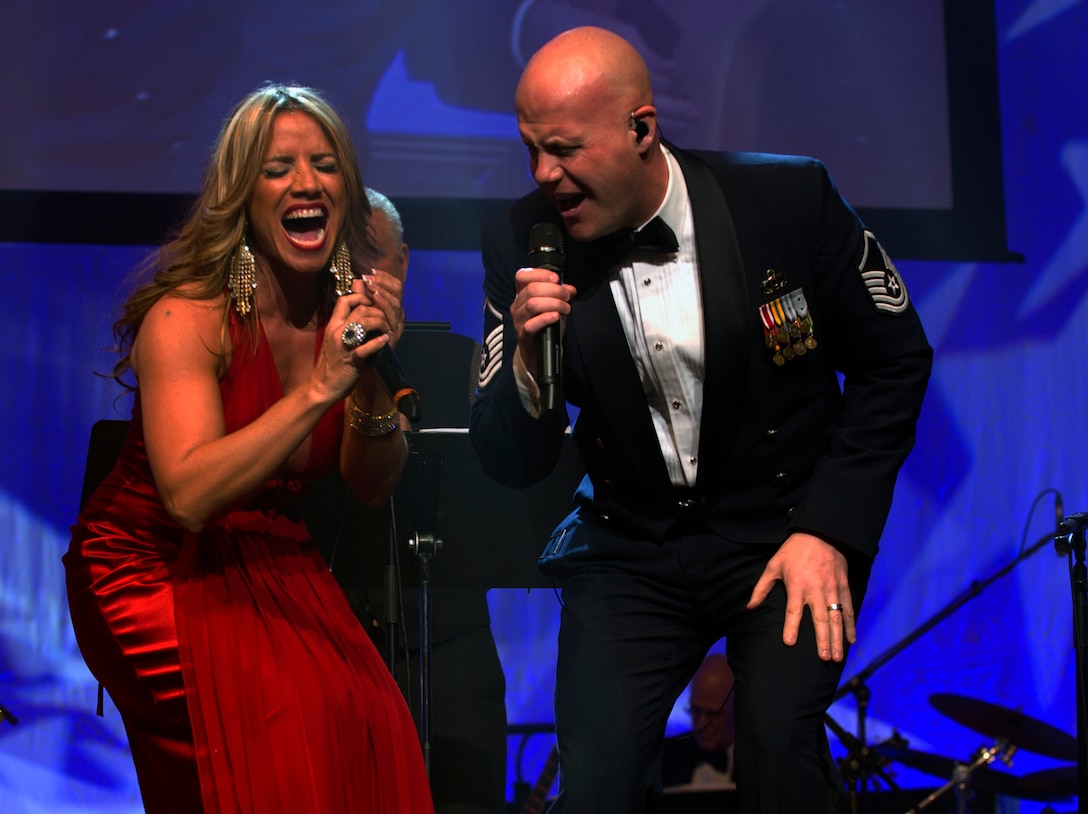 Melina Leon, Latin singer and actress, and Master Sgt. Ryan Carson, Max Impact vocalist, perform a duet during a Guest Artist Series concert Feb. 10, 2013 in Washington, D.C. This was the first of three concerts in the 2013 Guest Artist Concert series, which will feature guest artists “The Rogues,” a Scotish/Celtic rock band, and country music sensation Lee Greenwood. (U.S. Air Force photo/Senior Airman Bahja Joi Jones) 