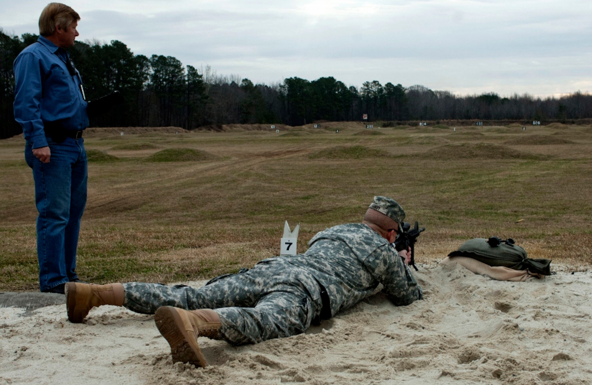 U.S. Army Brig. Gen. Michael Lundy, Combined Arms Center-Training deputy commanding general, gets a hands-on look at the redesigned Location of Miss and Hit System with Dennis Terry, Training and Doctrine Capability Manger-Live Sustainable Range Program manager at Range 3 on Fort Eustis, Va., Feb. 5, 2013. The LOMAH system is a computer-controlled projectile detection target system that automatically triangulates shot groups to provide the shooter with corrective data through a wireless local area network. (U.S. Air Force photo by Airman 1st Class R. Alex Durbin/Released)