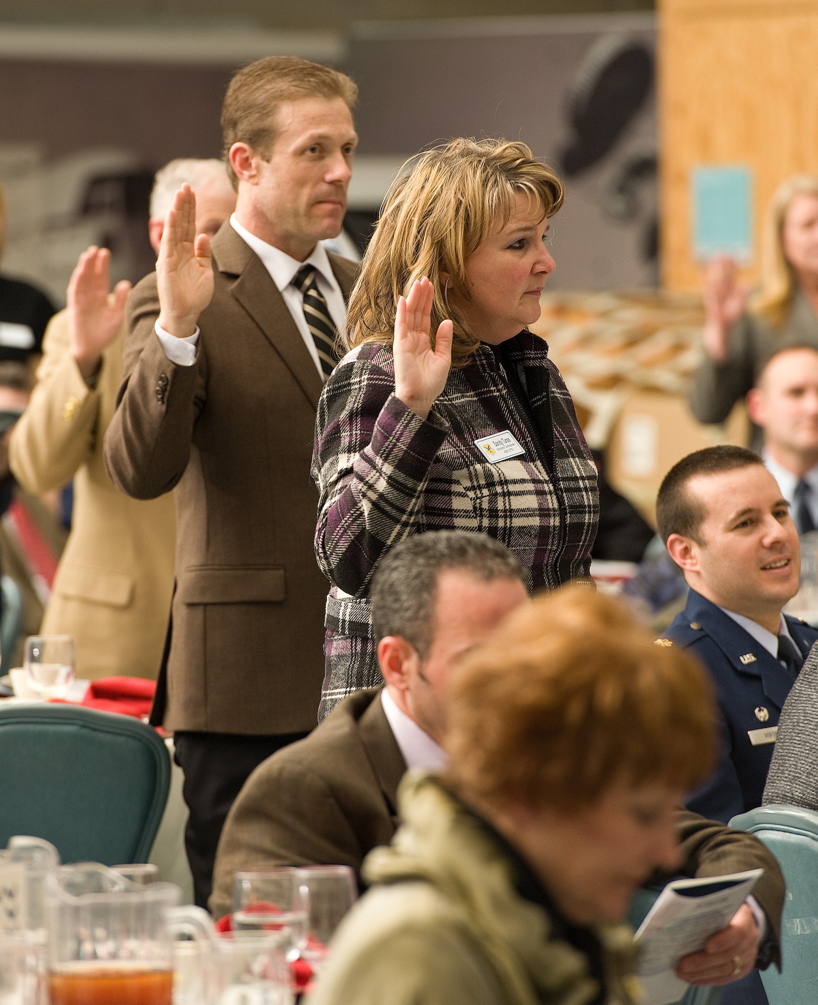 A.C. Lucas, left, Production Planner at Fordham and Old Dominion Brewing Company, Dover, Del., and Sandy Taras, Chief Financial Officer of PATS Aircraft Systems, Georgetown, Del., take the honorary commander oath, Feb. 9, 2013, at Dover Air Force Base, Del. Cols. Rick Moore and Raymond Kozak, commanders of the 436th and 512th Airlift Wings, respectively, at Dover AFB, administered the oath to the 2013 Honorary Commanders. (U.S. Air Force photo/Roland Balik)
