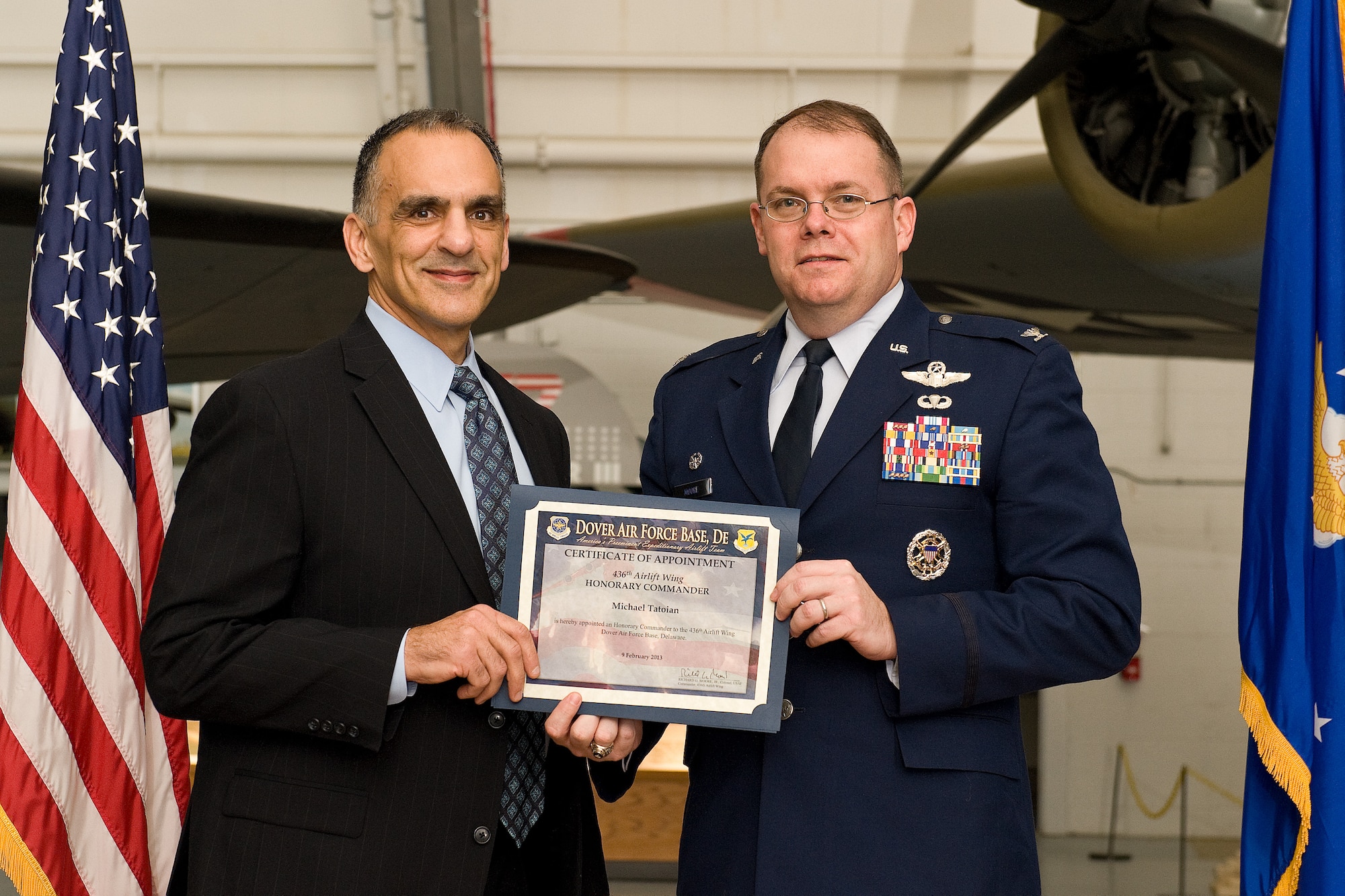 Col. Rick Moore, right, commander of the 436th Airlift Wing, welcomes incoming honorary commander, Michael Tatoian, Executive Vice President and Chief Operations Officer, Dover Motorsports, Inc., Feb. 9, 2013, at Dover Air Force Base, Del. Tatoian was one of forty-six civic leaders inducted onto the Dover AFB honorary commander program during a ceremony held at the Air Mobility Command Museum. (U.S. Air Force photo/Roland Balik)