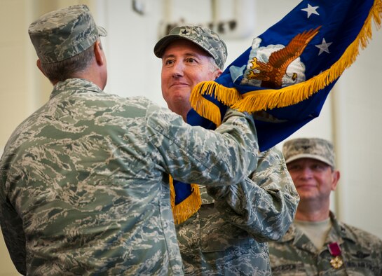 Former 919th Special Operations Wing commander, Brig. Gen. Jon Weeks accepts the Air Force Special Operations Air Warfare Center guidon as its first leader at an activation ceremony at Duke Field, Fla., Feb. 11.  The new center is Weeks’ third special operations command.  The AFSOAWC will combine the efforts of units across AFSOC that work with doctrine development, education, training and execution of the command’s irregular warfare capabilities.  The center will bring together more than 500 active-duty and reserve Airmen through total force integration.  (U.S. Air Force photo/Tech. Sgt. Samuel King Jr.)