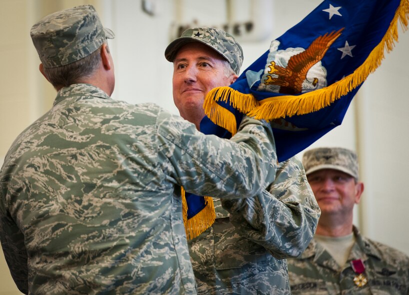 Former 919th Special Operations Wing commander, Brig. Gen. Jon Weeks accepts the Air Force Special Operations Air Warfare Center guidon as its first leader at an activation ceremony at Duke Field, Fla., Feb. 11.  The new center is Weeks’ third special operations command.  The AFSOAWC will combine the efforts of units across AFSOC that work with doctrine development, education, training and execution of the command’s irregular warfare capabilities.  The center will bring together more than 500 active-duty and reserve Airmen through total force integration.  (U.S. Air Force photo/Tech. Sgt. Samuel King Jr.)
