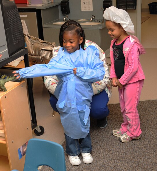 Jayden Echols, daughter of Staff Sgt. Ashley Fuquay, and Samyra Jackson, daughter of MSgt. Jennifer Jackson, put on scrubs to perform a play as part of National Children's Dental Health Month on Barksdale Air Force Base, La., Feb. 12. Members from the 2nd Dental Squadron visited the Child Development Center West to demonstrate the proper ways to brush your teeth. (U.S. Air Force photo/ Senior Airman Sean Martin)
