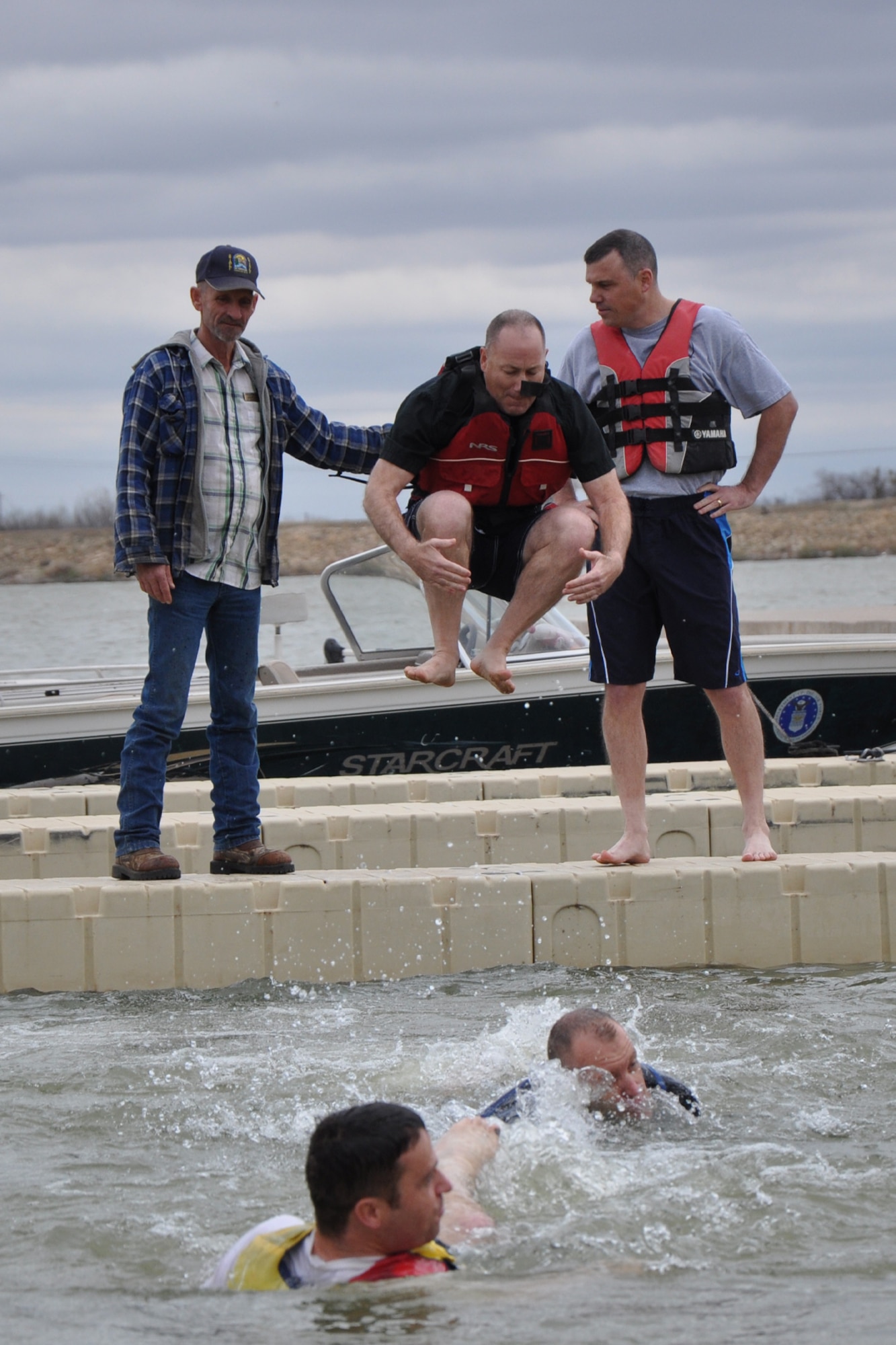 SAN ANGELO, Texas – Lt. Col. Stephen Nicolai, 17th Training Wing Chaplain, does a cannonball into the 46 degree water of Lake Nasworthy during the 2013 Goodfellow Outdoor Recreation Camp Polar Bear Plunge, Feb. 9. Chaplain Nicolai was one of more than 80 participants in the 2013 plunge. (U.S. Air Force photo/ Staff Sgt. Robert Smith)