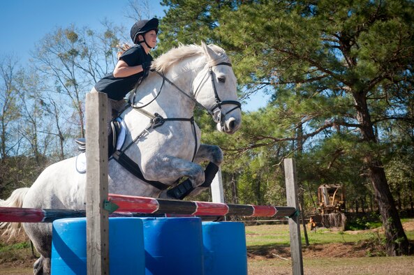 U.S. Air Force Staff Sgt. Stacey Chastain, 23d Wing Judge Advocate military justice paralegal, jumps over a fence outside a stable in Valdosta, Ga., Feb. 3, 2013. Chastain competes in equestrian three-day eventing for the Air Force equestrian team. (U.S. Air Force photo by Senior Airman Jarrod Grammel/Released)
