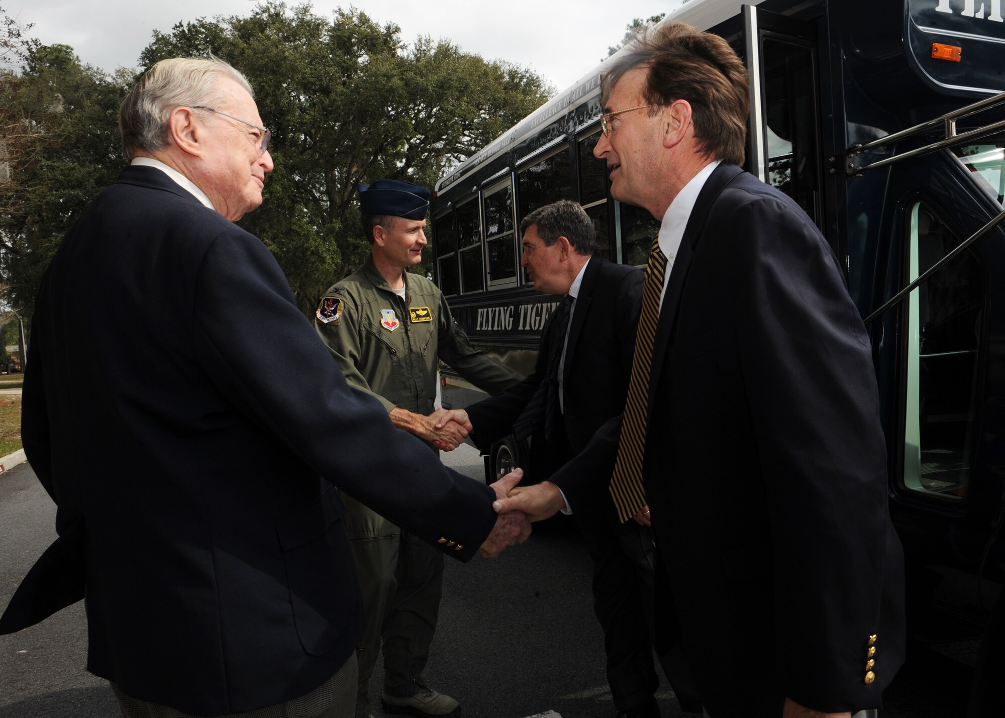 Parker Greene (left), executive director of the Moody Support Committee, and U.S. Air Force Col. Billy Thompson, 23d Wing commander, greet and shake hands with Georgia Military Affairs Coordinating Committee (GMACC) members Wayne Arny (right), and William Ball at Moody Air Force Base, Ga., Feb. 11, 2013. The GMACC visited Moody to meet with leadership for a joint brief discussing the role Moody plays in the community and Air Force. (U.S. Air Force photo by Senior Airman Eileen Meier/Released)