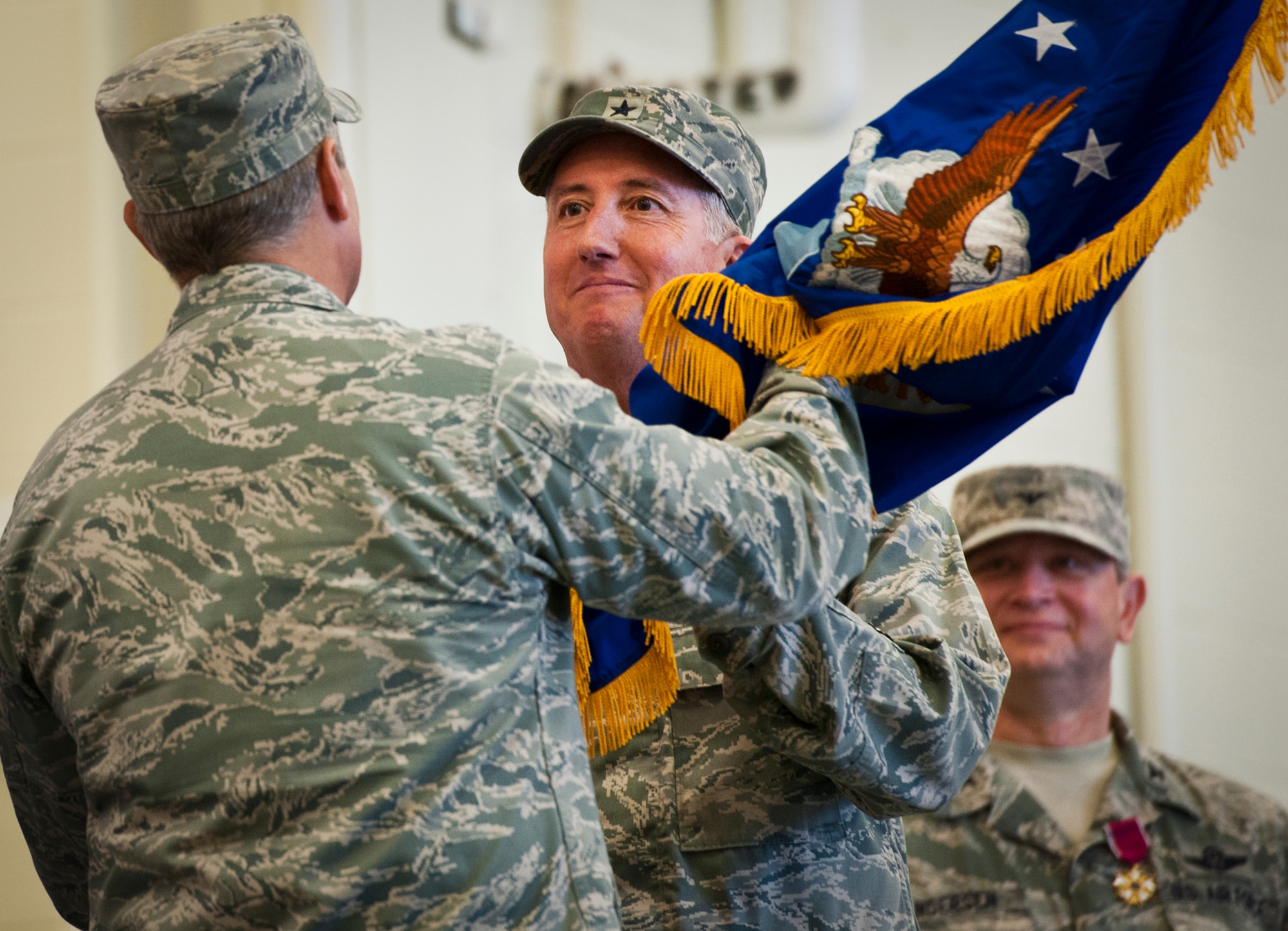 U.S. Air Force Brig. Gen. Jon Weeks, commander of Air Force Special Operations Air Warfare Center, right, takes the AFSOAWC flag from Lt. Gen. Eric Fiel, commander of Air Force Special Operations Command, left, during a ceremony held on Duke Field, Fla., Feb. 11, 2013. The ceremony was held for the deactivation of the Air Force Special Operations Training Center and the activation and assumption of command of the AFSOAWC. (U.S. Air Force photo/Samuel King)
